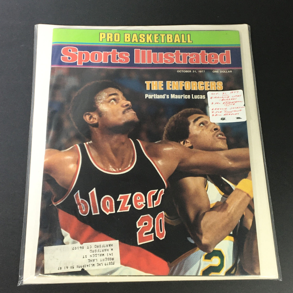 Sports Illustrated Magazine from October 31, 1977, encapsulated for protection, featuring Portland's Maurice Lucas on the cover with the title 'The Enforcers'.