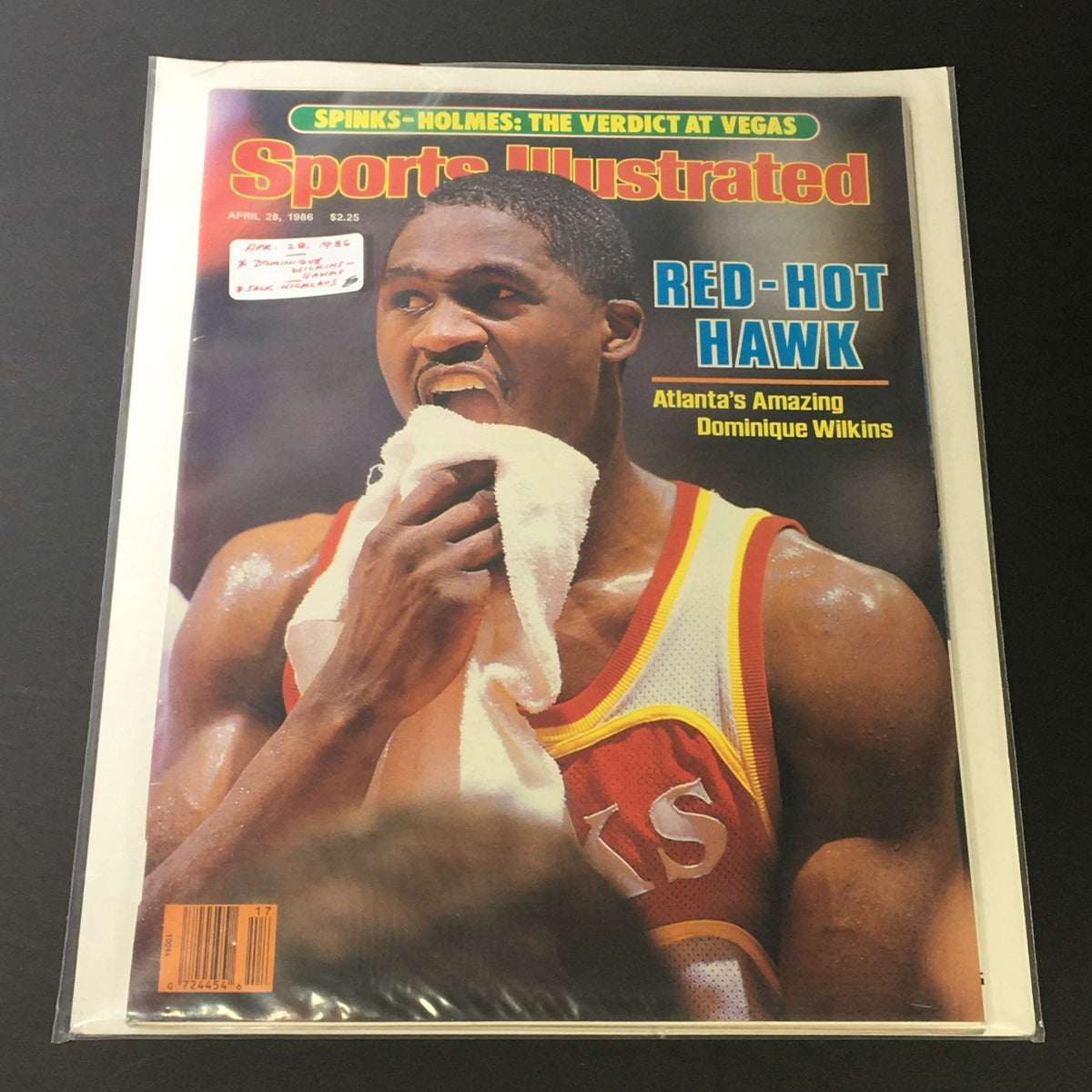 Cover of Sports Illustrated magazine April 28, 1986, highlighting Dominique Wilkins with the headline 'Red-Hot Hawk' and showcasing his athletic prowess.
