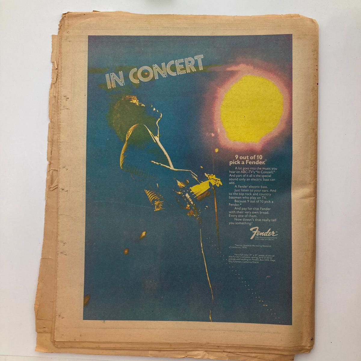 Vintage Rolling Stone Magazine December 19, 1974 featuring George Harrison on the cover, showcasing an old advertisement for Fender guitars with a musician in concert. Perfect collectible for music history enthusiasts.