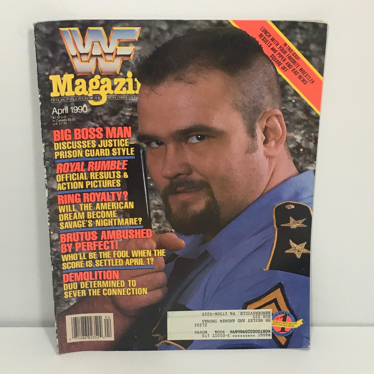 WWF/WWE Magazine April 1990 featuring Big Boss Man on the cover, discussing justice and prison guard style. Includes highlights on Royal Rumble, ring royalty, Brutus ambushed by Perfect, and Demolition. Vintage wrestling magazine in good condition.