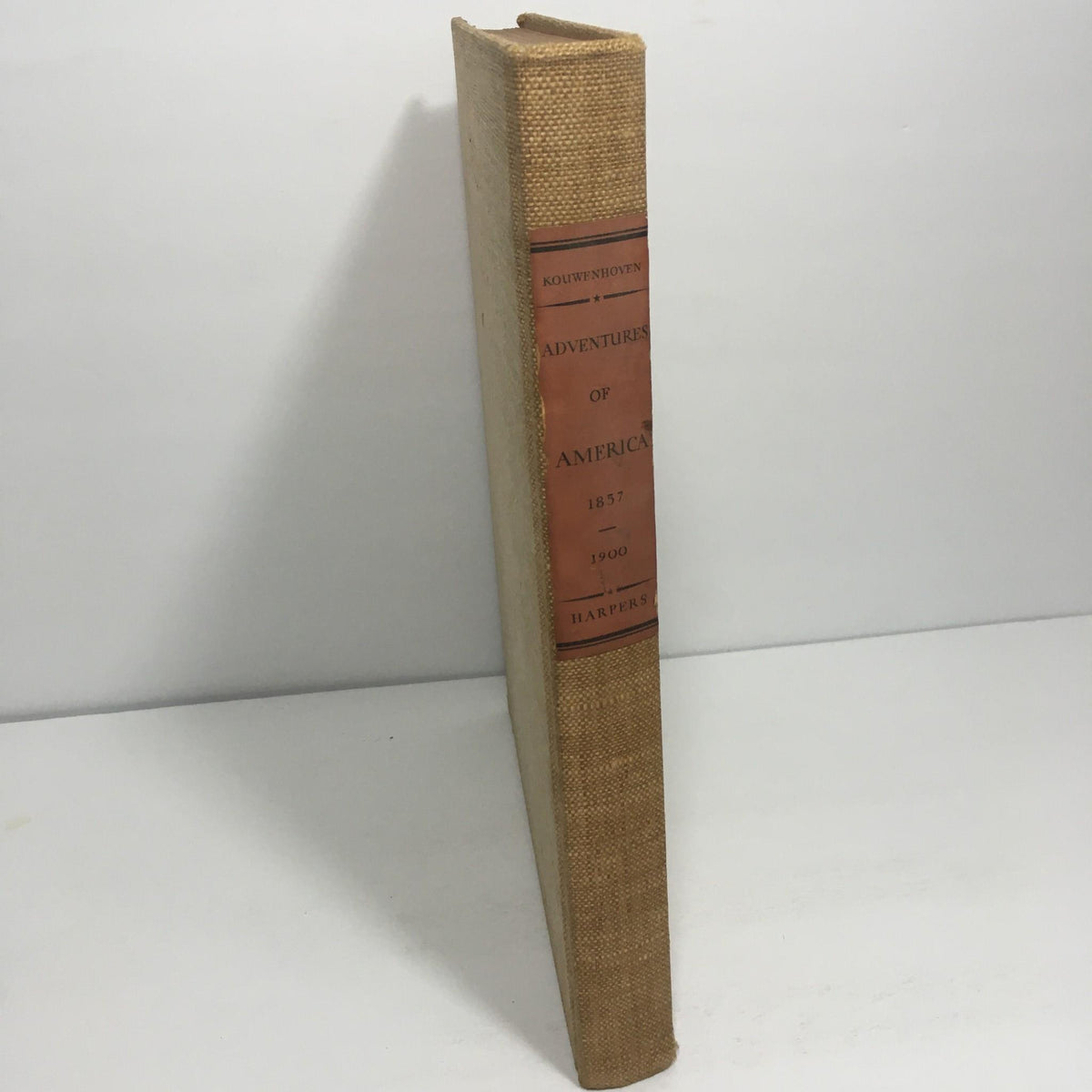 Spine view of 'Adventures of America 1857 - 1900' by John Kouwenhoven, showing the book title prominently displayed.