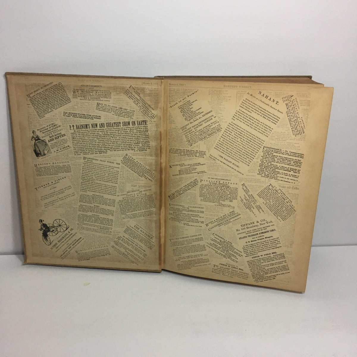 Interior view of 'Adventures of America 1857 - 1900' by John Kouwenhoven, showcasing pages with collaged newspaper clippings.