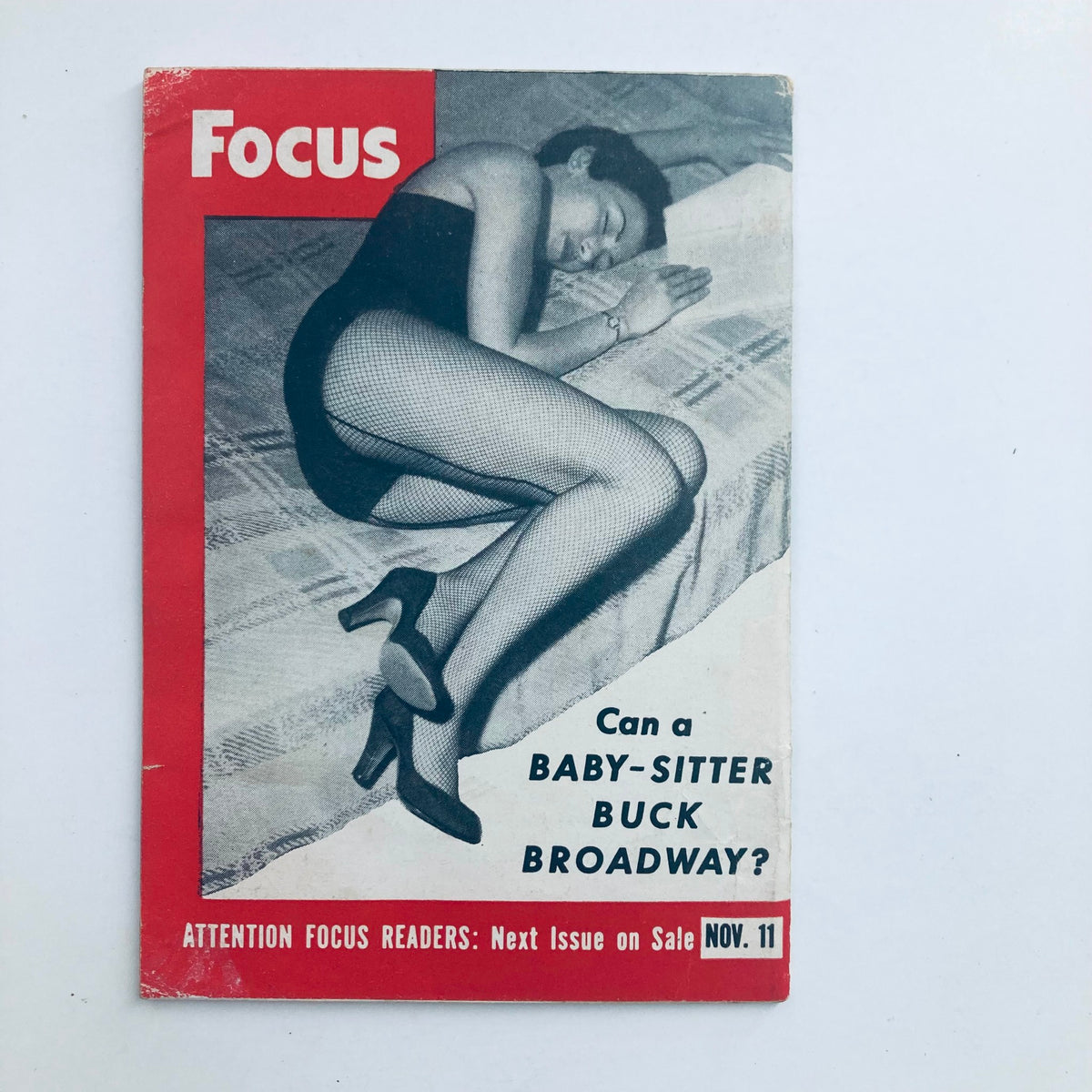 Back cover of VTG Focus Magazine November 11 1953 featuring an illustration of a woman in a swimsuit with the headline 'Can a Baby-Sitter Buck Broadway?'.