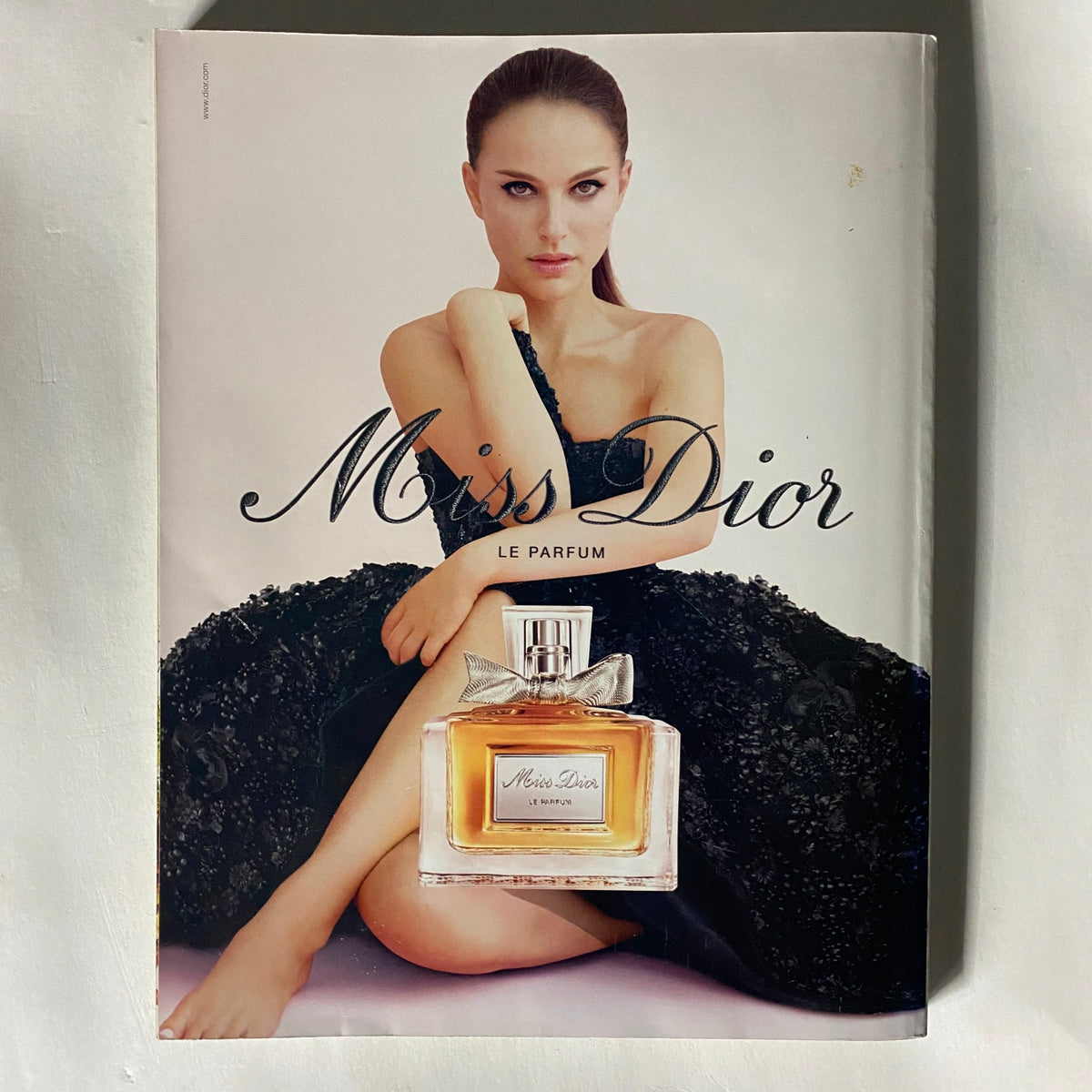 Advertising page in Vogue UK Magazine October 2013 featuring Miss Dior perfume, highlighted by an elegant image of a model in a black gown.