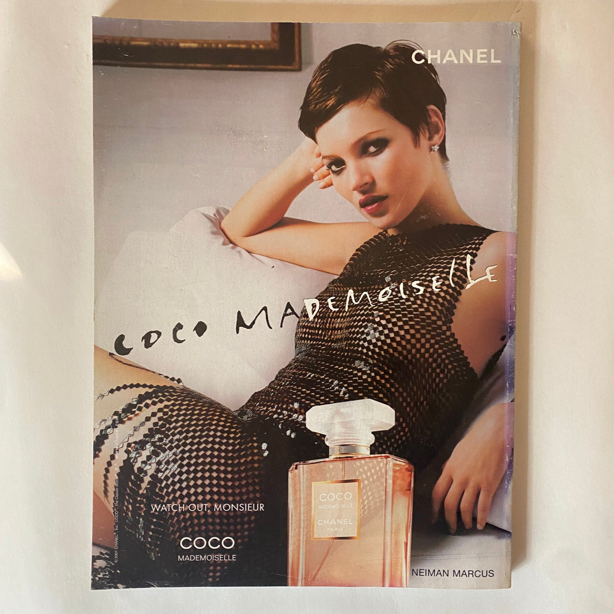 Advertisement page from Elle Magazine November 2003 for Chanel Coco Mademoiselle perfume, featuring a fashionably dressed model, reflecting early 2000s beauty trends.