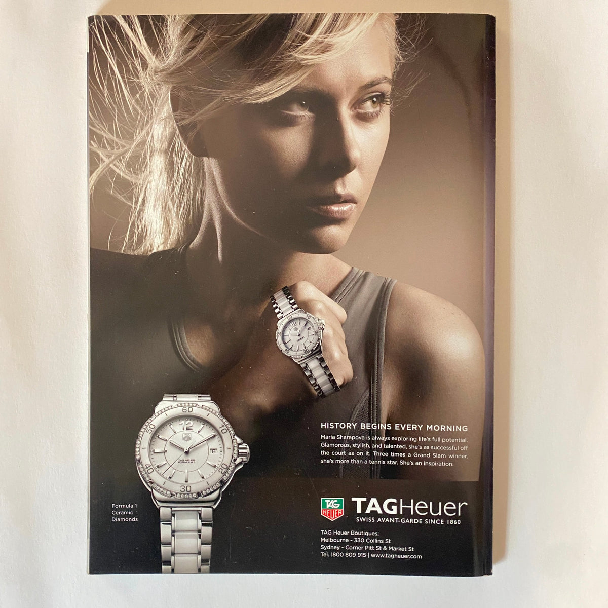 Advertisement for TAG Heuer in Harper's Bazaar Australia Magazine May 2011, featuring a model elegantly showcasing a luxury watch, highlighting sophistication and style.