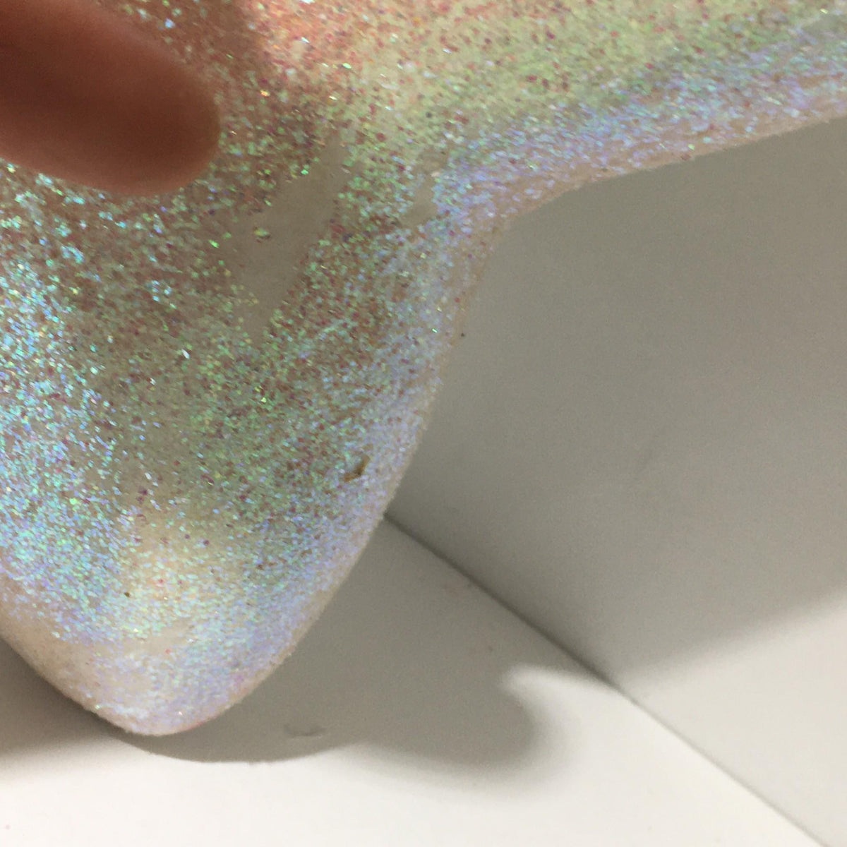 Side angle of the glittery star ornament for Macy's Thanksgiving Day Parade, emphasizing the shimmering finish.