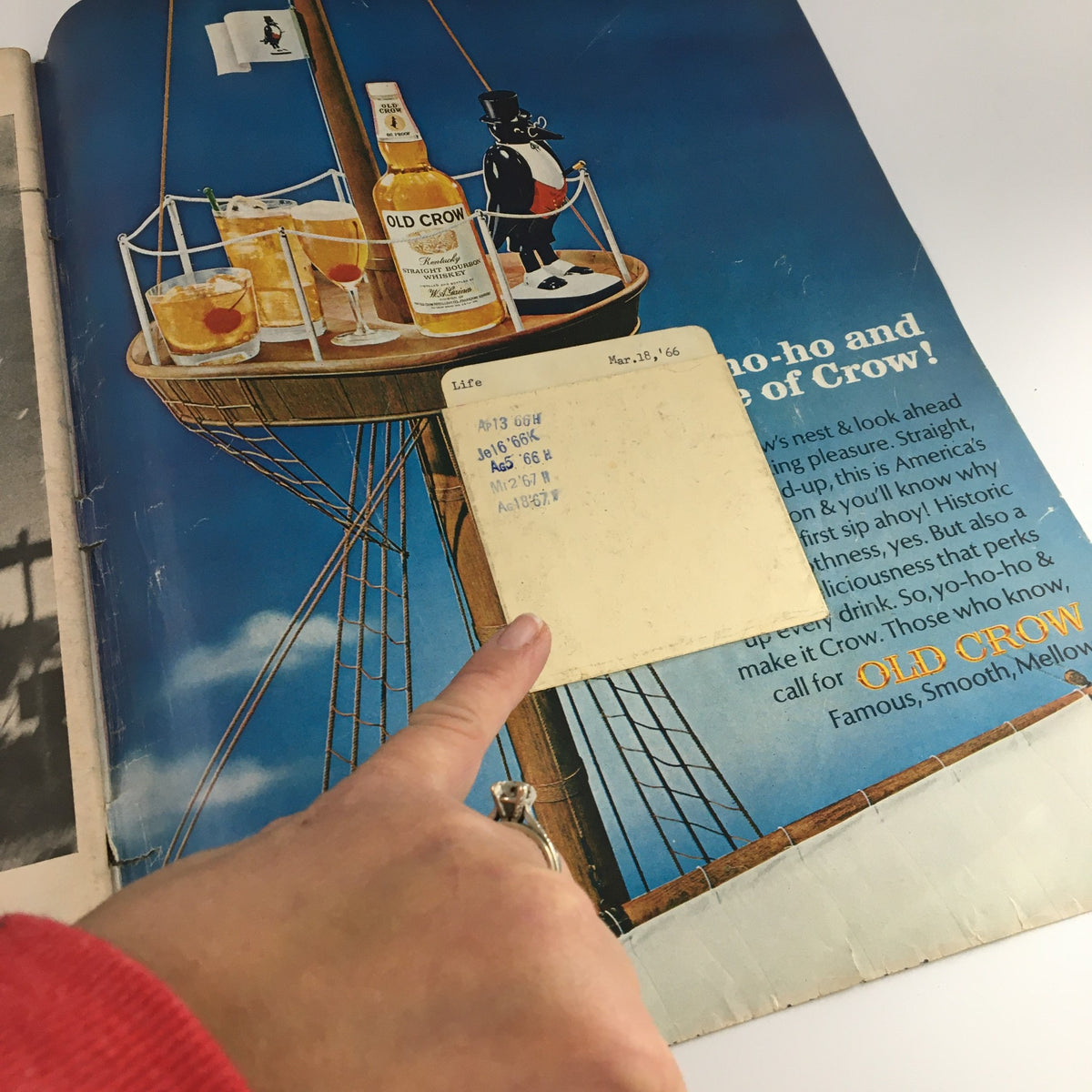 Inside page of VTG Life Magazine March 18 1966 showing an advertisement for Old Crow whiskey and a library card envelope, highlighting the magazine's vintage charm.