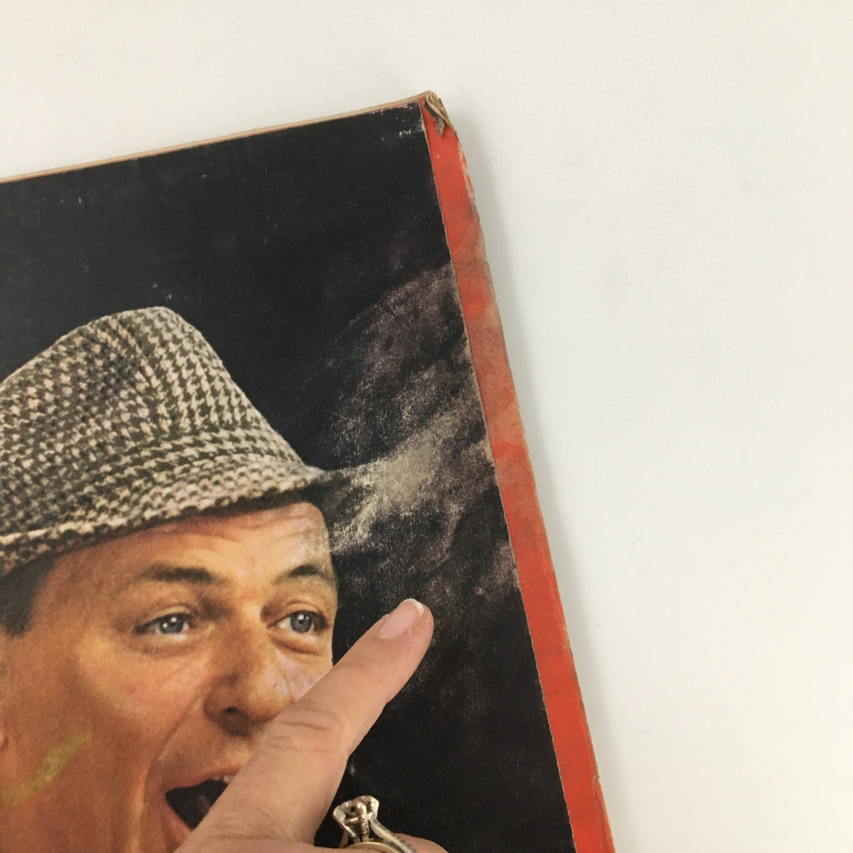 Detail view of the cover of VTG Life Magazine April 23 1965, highlighting Frank Sinatra's face and hat, with an emphasis on the wear of the magazine that adds to its vintage charm.