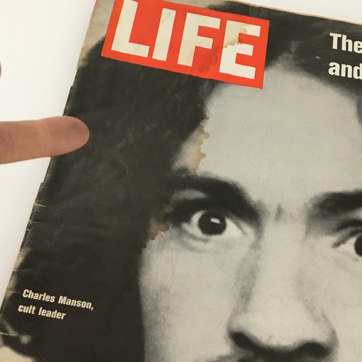 Close-up view of the VTG Life Magazine December 19, 1969 cover, highlighting Charles Manson, cult leader, with visible wear and water damage.