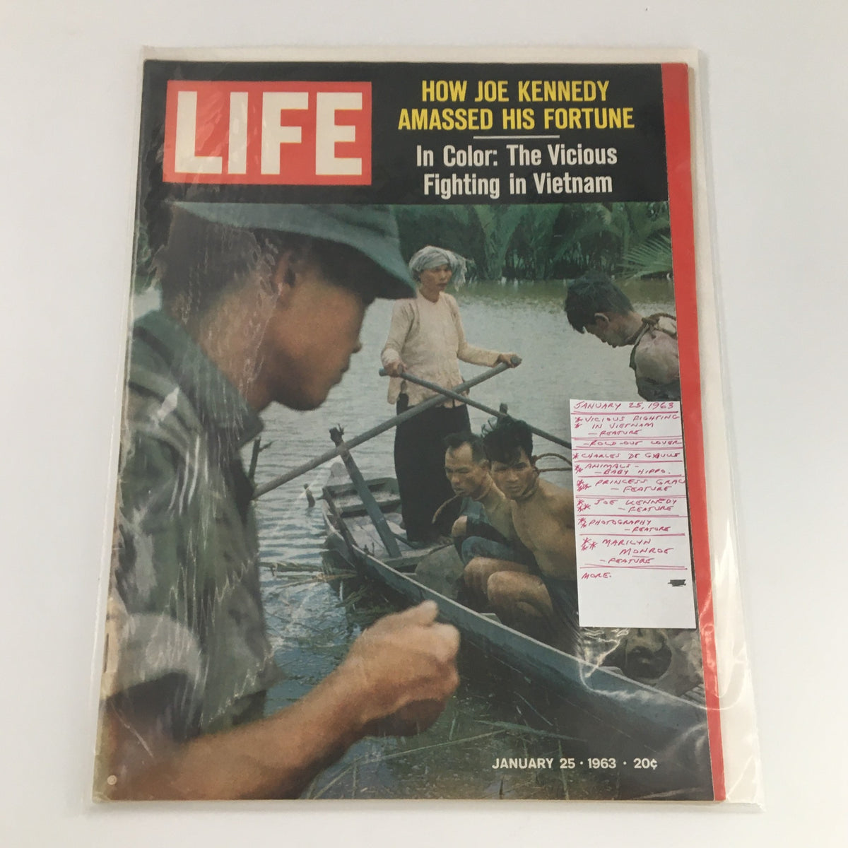 VTG Life Magazine January 25 1963 enclosed in protective cover, featuring the iconic cover image depicting the vicious fighting in Vietnam and additional notes about the magazine's contents.