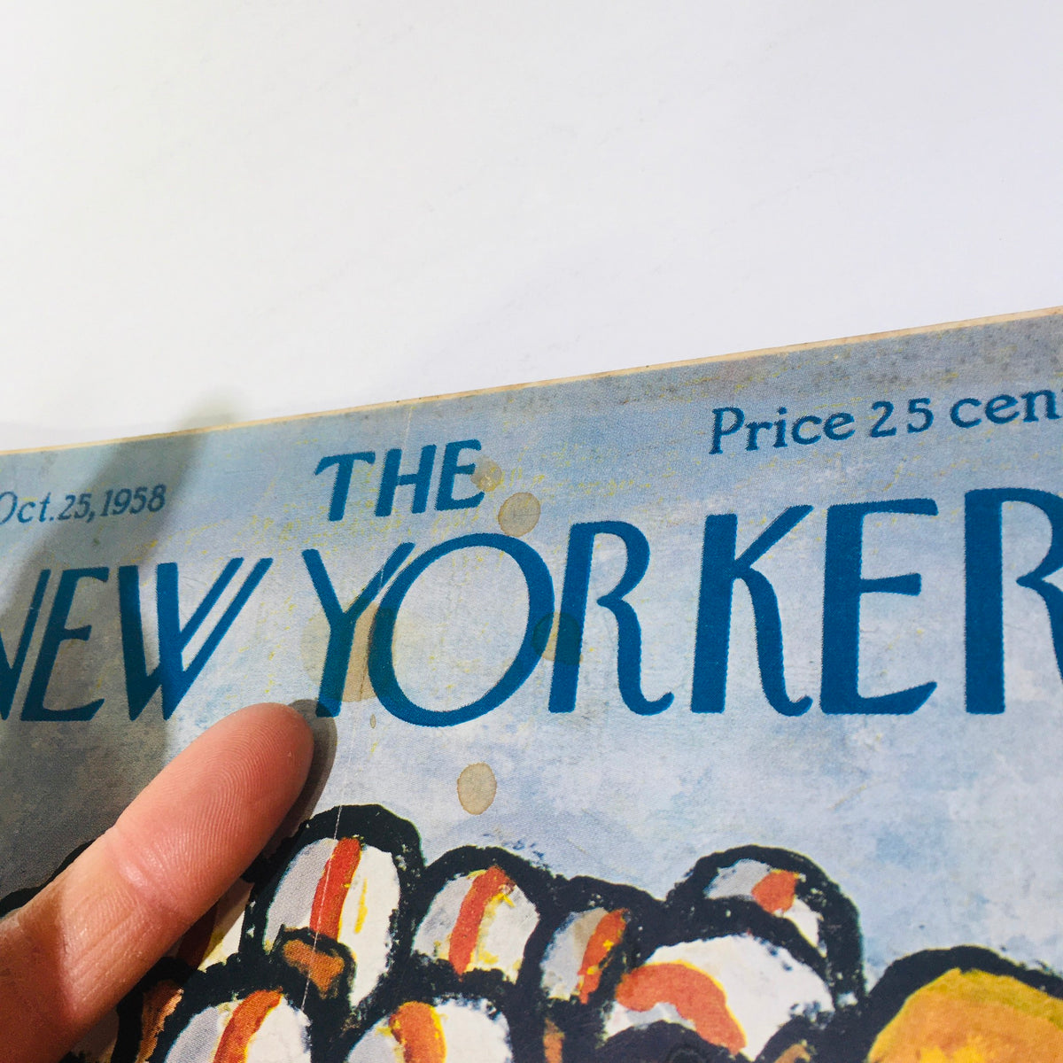 Close-up of The New Yorker Magazine cover, dated October 25, 1958, highlighting the magazine's title and details with a finger pointing at it.