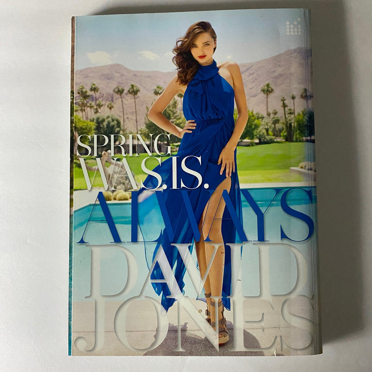 Cover of David Jones Spring 2011 catalog featuring a model in a vibrant blue dress, representing a blend of fashion and lifestyle inspirations, complementing the Harper's Bazaar Australia Magazine.