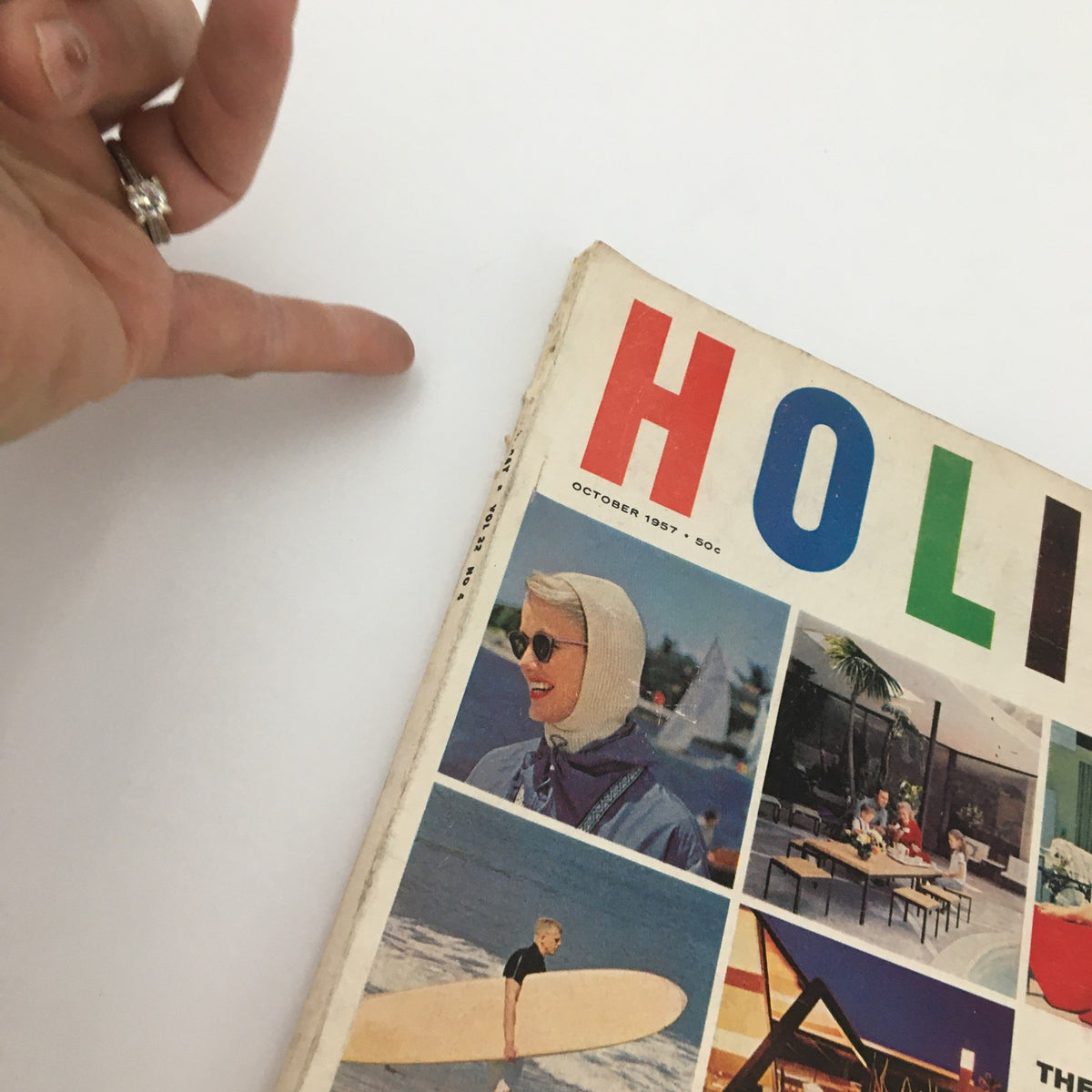 Close-up of the cover of VTG Holiday Magazine October 1957 showcasing a woman in sunglasses and a vintage hairstyle.