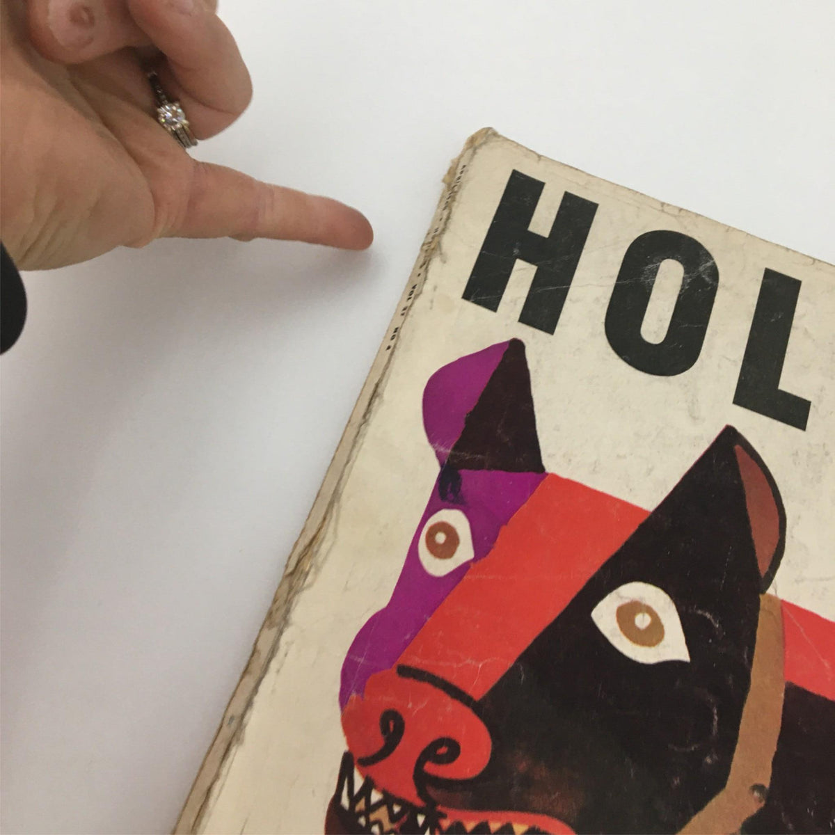 Side view of the VTG Holiday Magazine April 1960 with worn edges, showcasing its 1960s style and authentic vintage appeal.