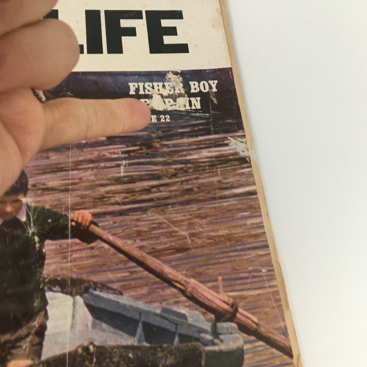 Detail view of VTG Boys' Life Magazine April 1969 cover highlighting the title 'Fisher Boy Orphan' and page number, emphasizing its vintage appeal.