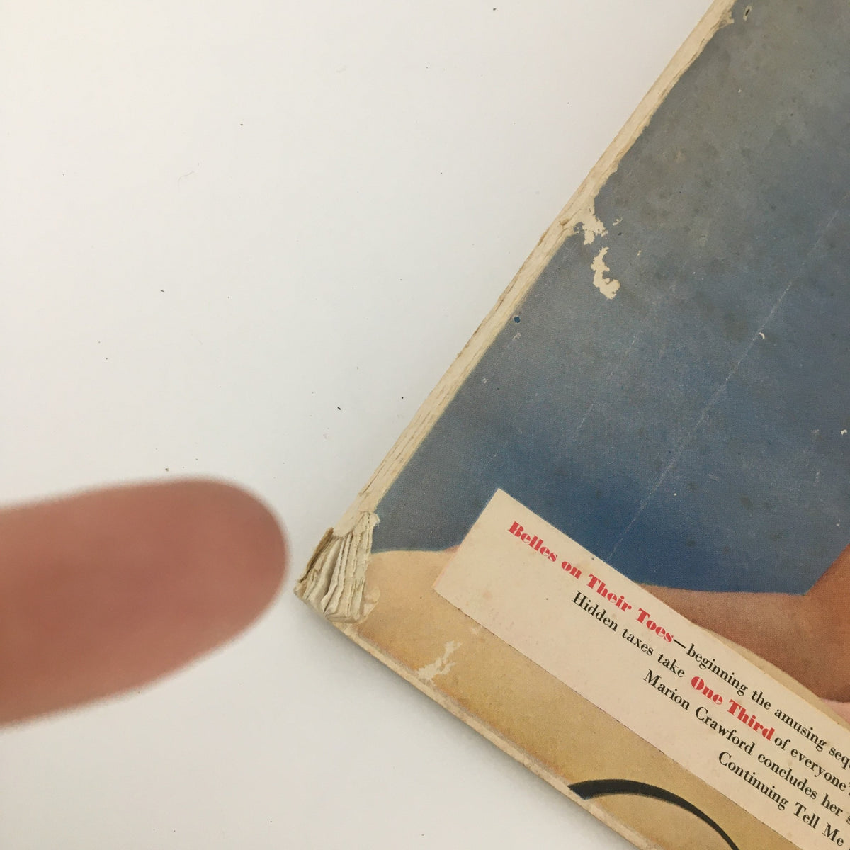 Close-up of VTG Ladies' Home Journal Magazine August 1950, showing wear on the binding and corner of the cover, highlighting its vintage condition.