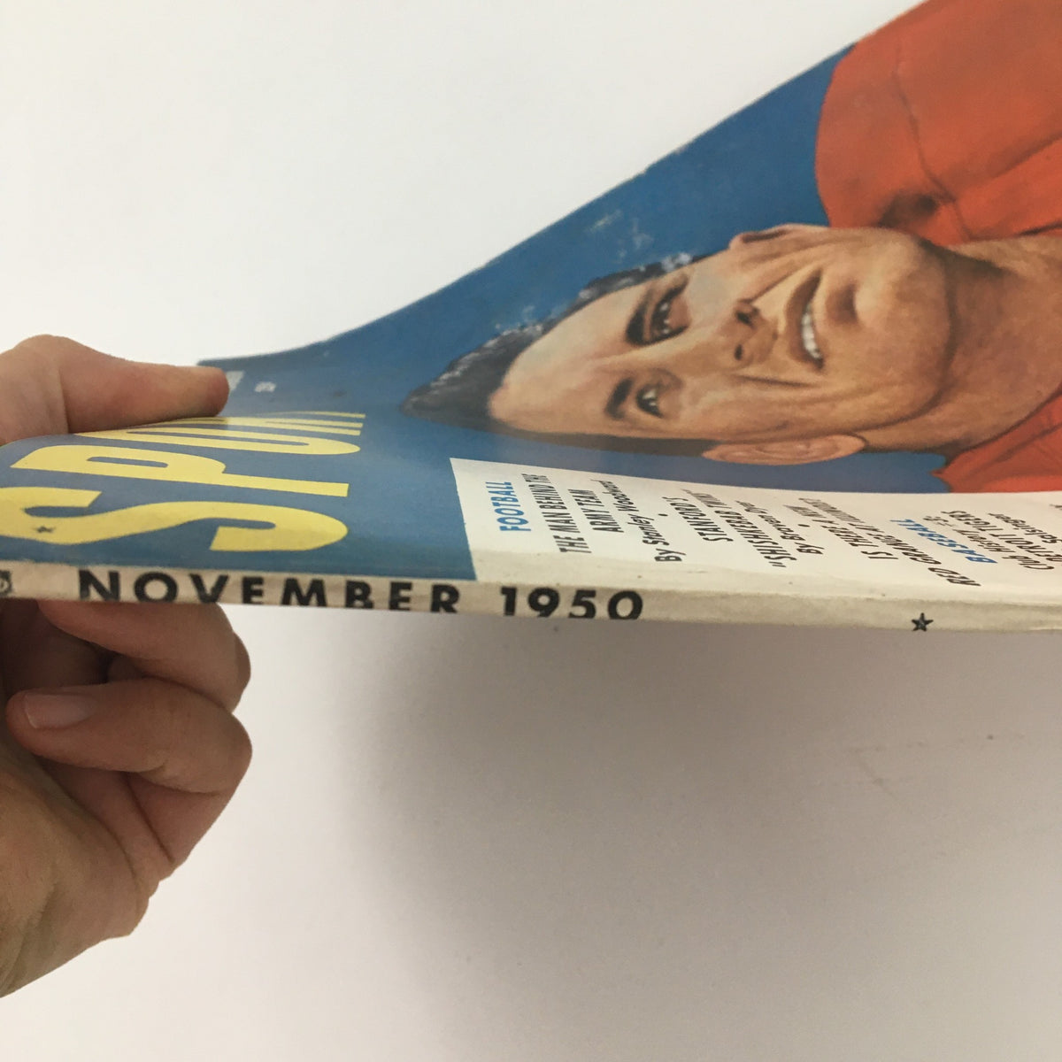 Side view of the VTG Sport Magazine November 1950 highlighting Harry Aganis, emphasizing the magazine's vintage condition and unique cover design.