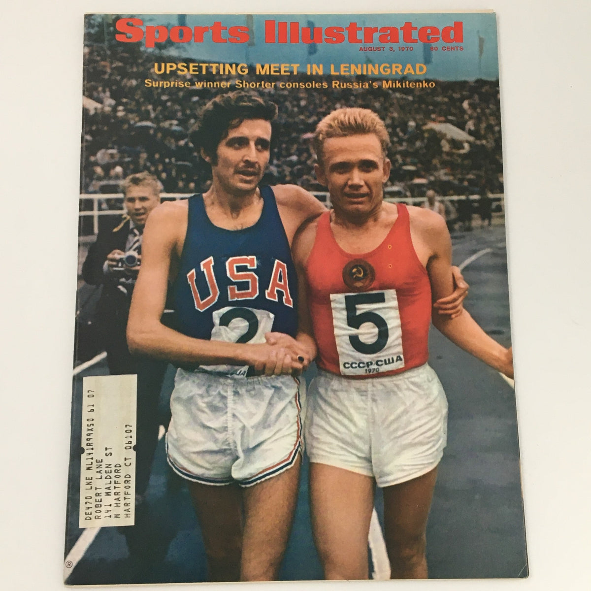 Cover of Sports Illustrated August 3, 1970, featuring Frank Shorter. The image shows Shorter embracing another runner after a race, highlighting a memorable moment in sports history.