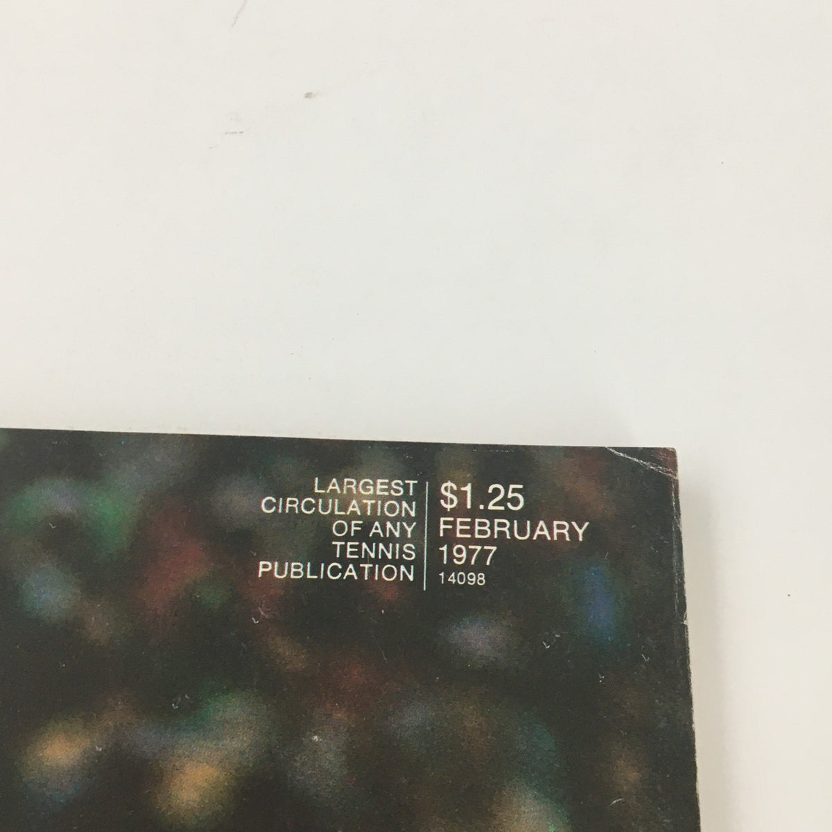 Close-up shot of the back cover of the February 1977 Tennis Magazine, highlighting its publication details and pricing.