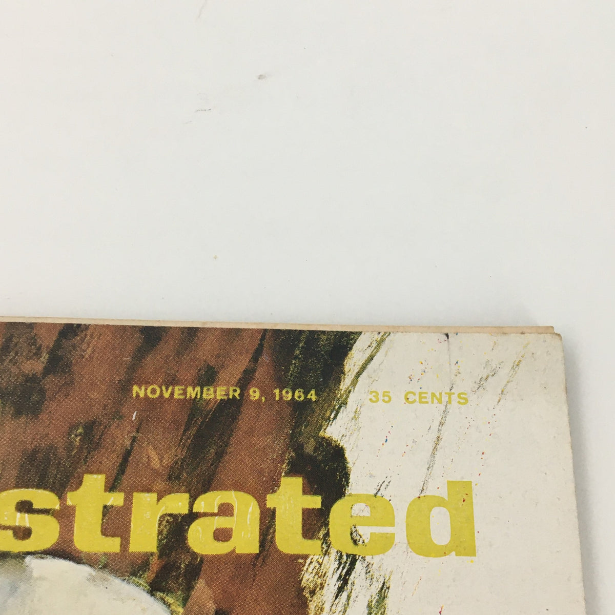 Close-up view of the top of the VTG Sports Illustrated Magazine November 9 1964, displaying the date and price, highlighting its vintage condition.