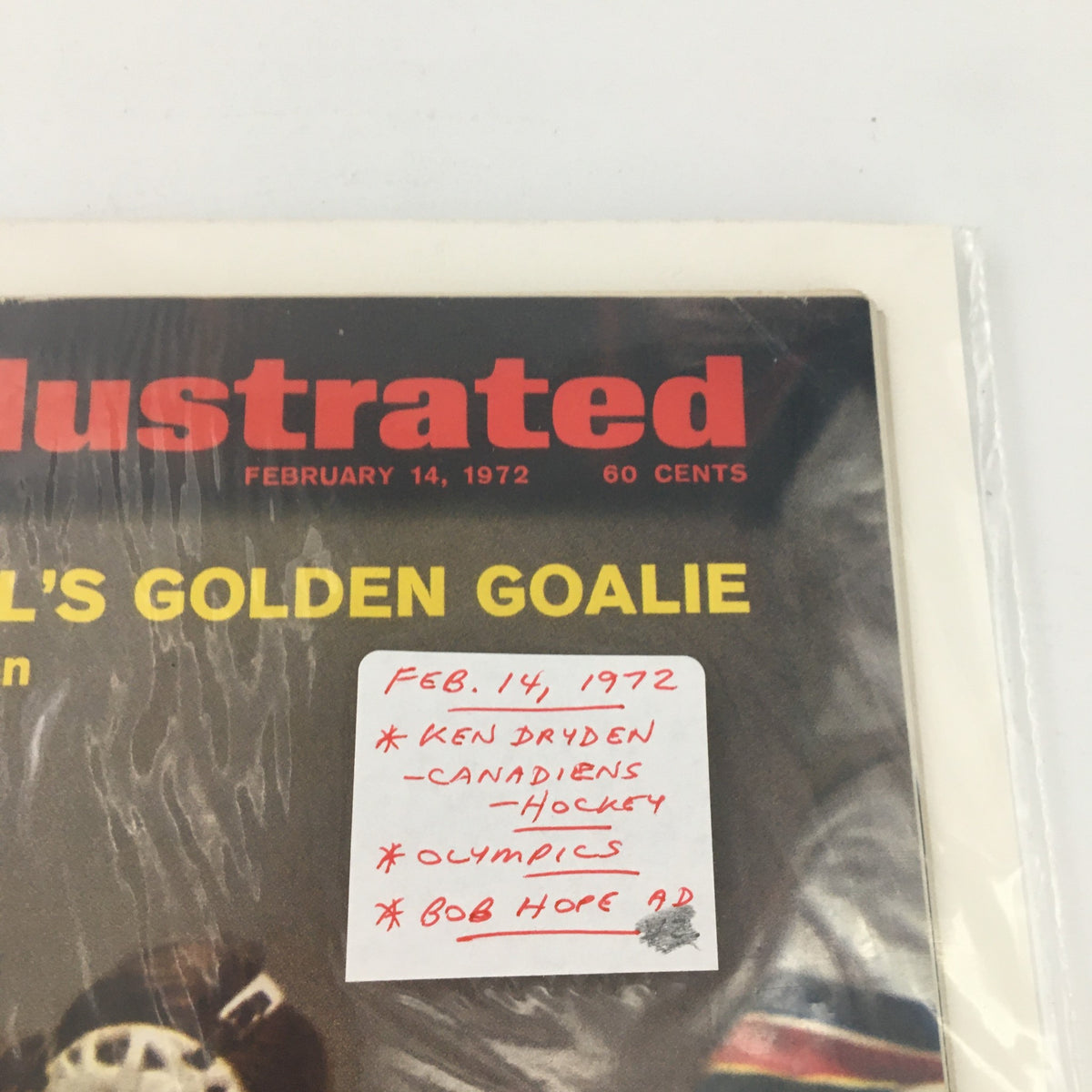 Close-up of the Sports Illustrated magazine cover from February 14, 1972, detailing Ken Dryden's features and a sticker emphasizing the issue's notable contents, including mentions of the Olympics and a Bob Hope advertisement.