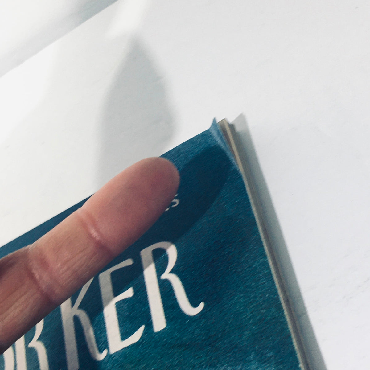 Close-up view of the cover of The New Yorker Magazine April 19 1969, showcasing the title with a finger holding the edge, highlighting its vintage appeal and condition.