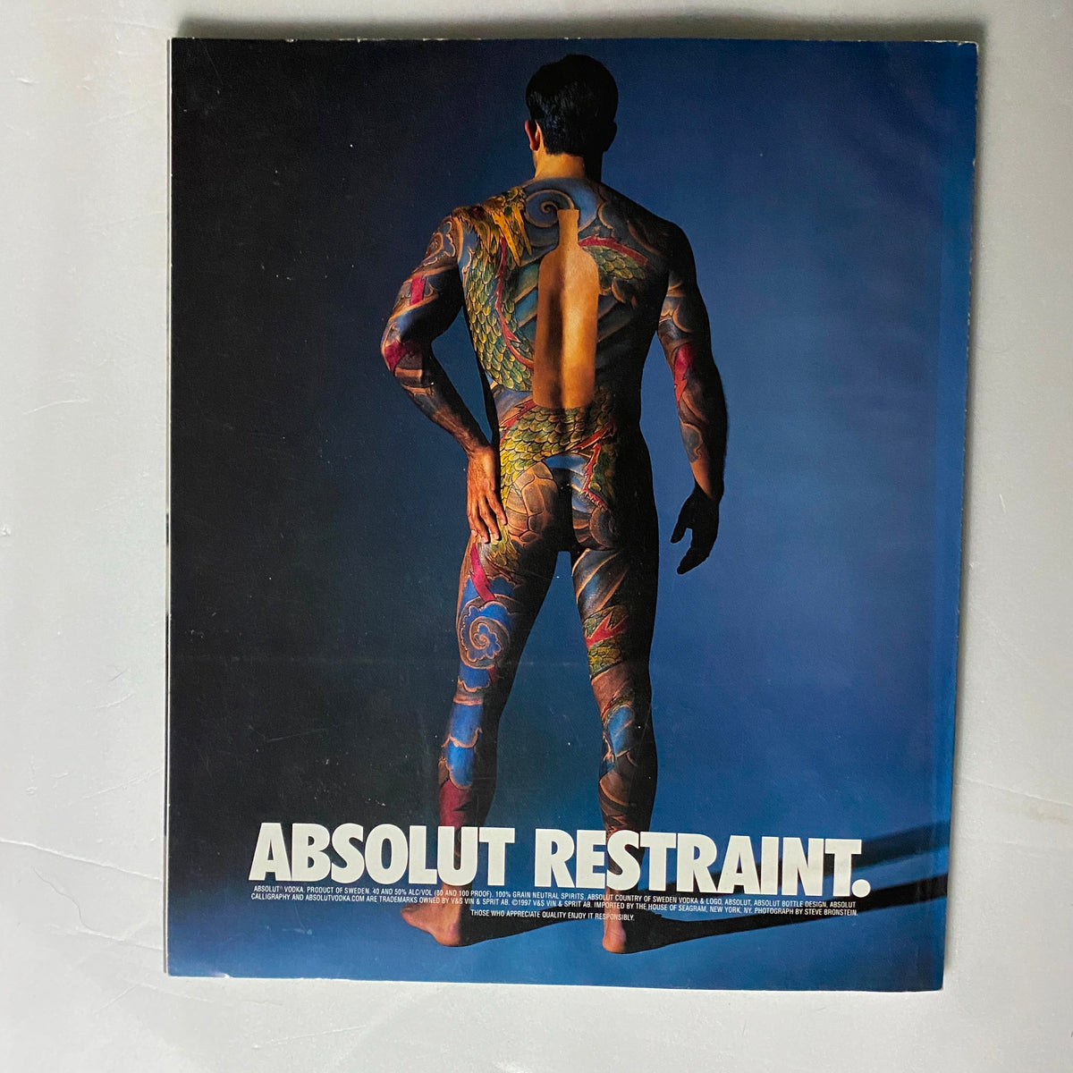 Cover of Bleach Magazine June 1998 featuring the title 'ABSOLUT RESTRAINT' with a model showcased from the back, displaying colorful tattoos against a dark blue background.