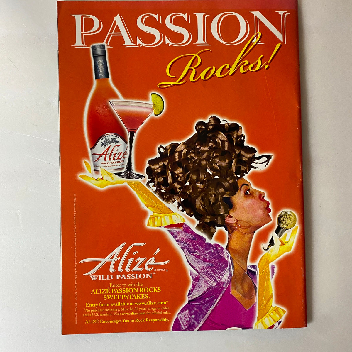 An advertisement for Alizé featured in the Fashion Rocks supplement to W Magazine, October 2004, promoting the Wild Passion drink.