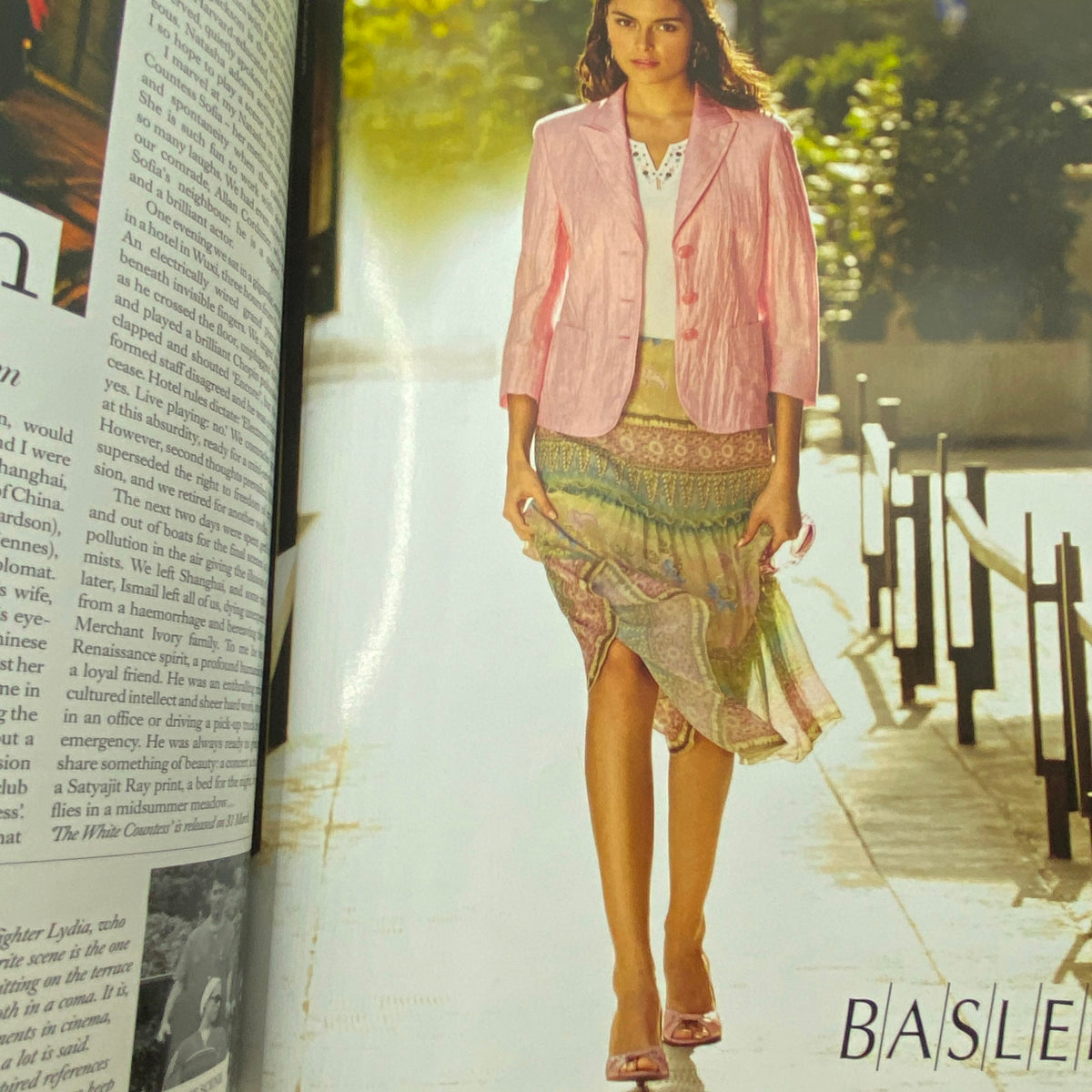 Model wearing a pink blazer and patterned skirt in Harper's Bazaar UK Magazine April 2006 Flávia de Oliveira Cover. Vintage fashion photography showcasing early 21st-century style.