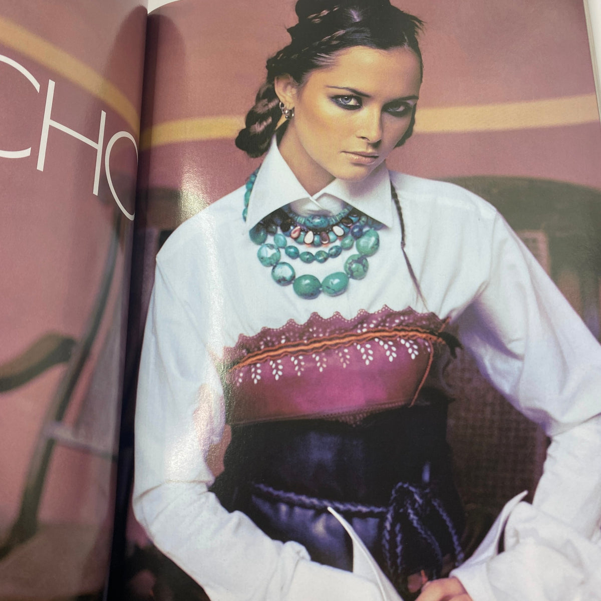 Fashion editorial image from Elle UK Magazine April 2004 showcasing a model adorned with statement jewelry and a unique outfit, emphasizing early 2000s style.