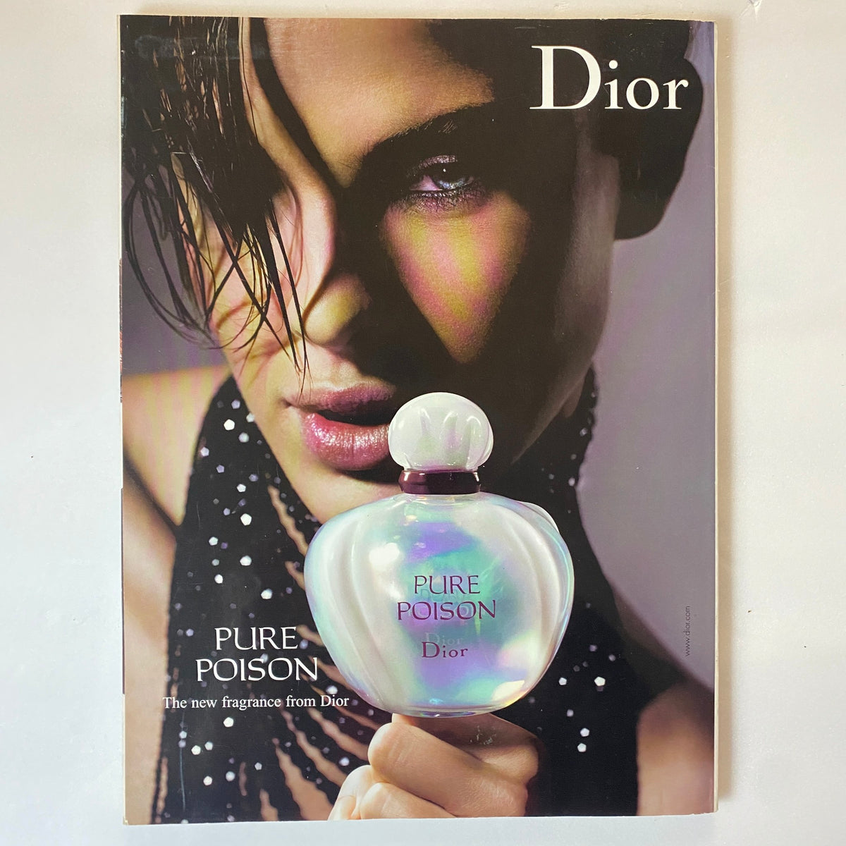 Cover of Dior's Pure Poison fragrance advertisement featured in Elle UK Magazine January 2005. The ad displays an artistic image of a model accentuating beauty and elegance, complementing the fashion theme of the magazine.