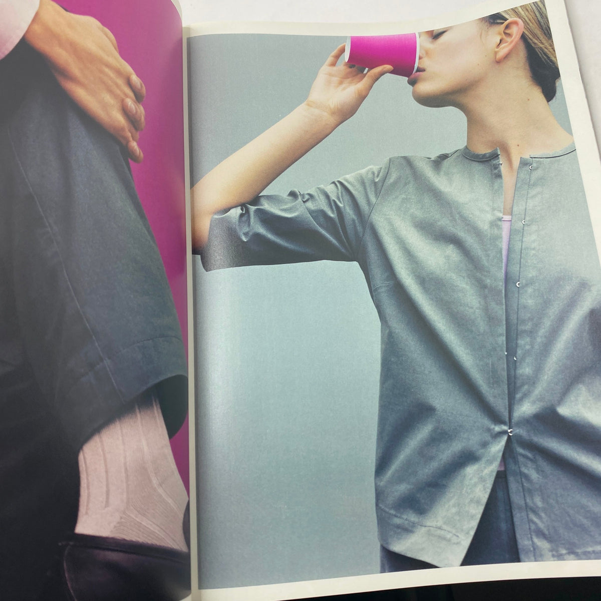 Fashion editorial page from Vanity Fair Magazine March 2000 displaying a model in stylish attire, featuring a gray outfit and a colorful purple cup.
