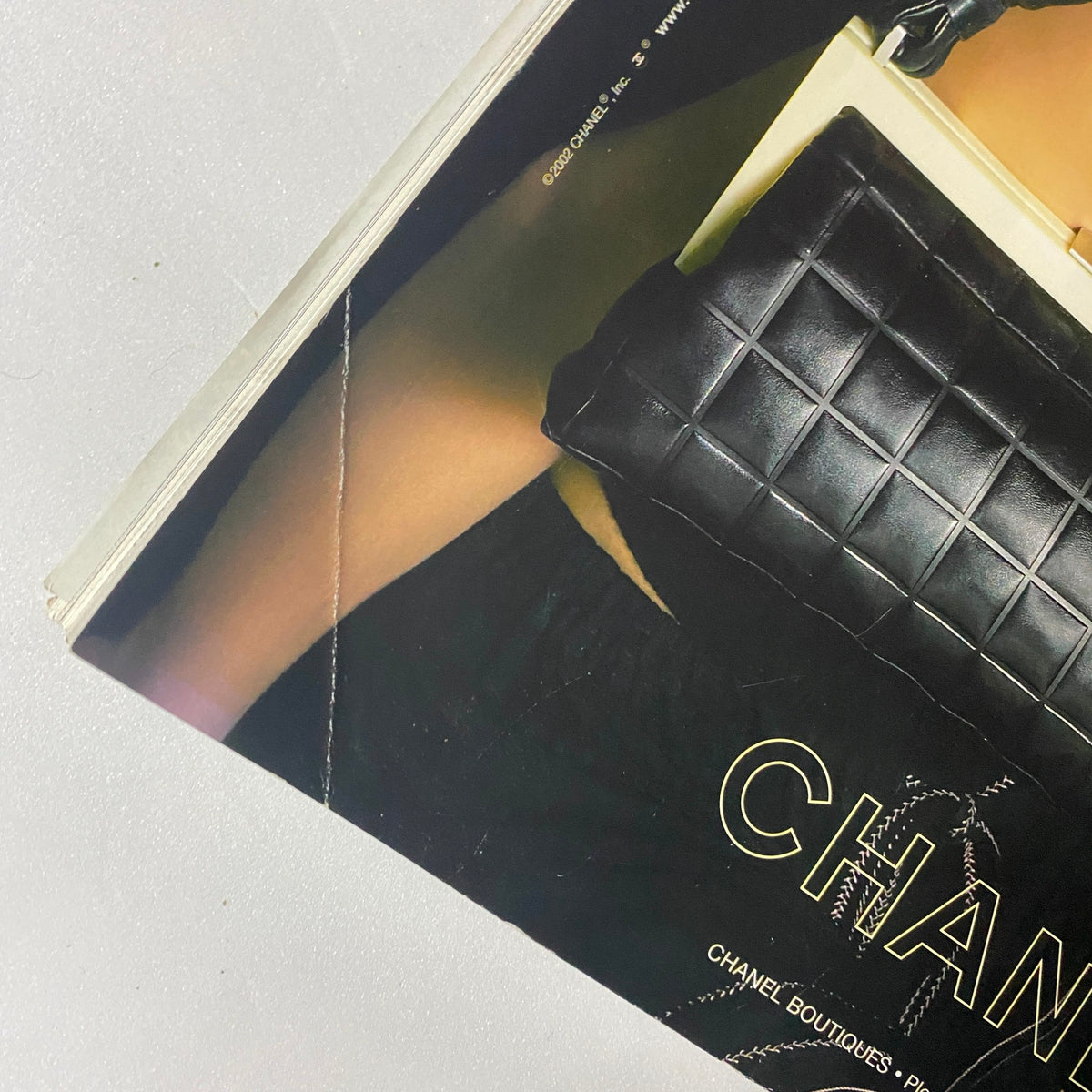 Close-up of Chanel handbag in Vanity Fair Magazine April 2002 highlighting the elegant design and details of the black quilted purse.