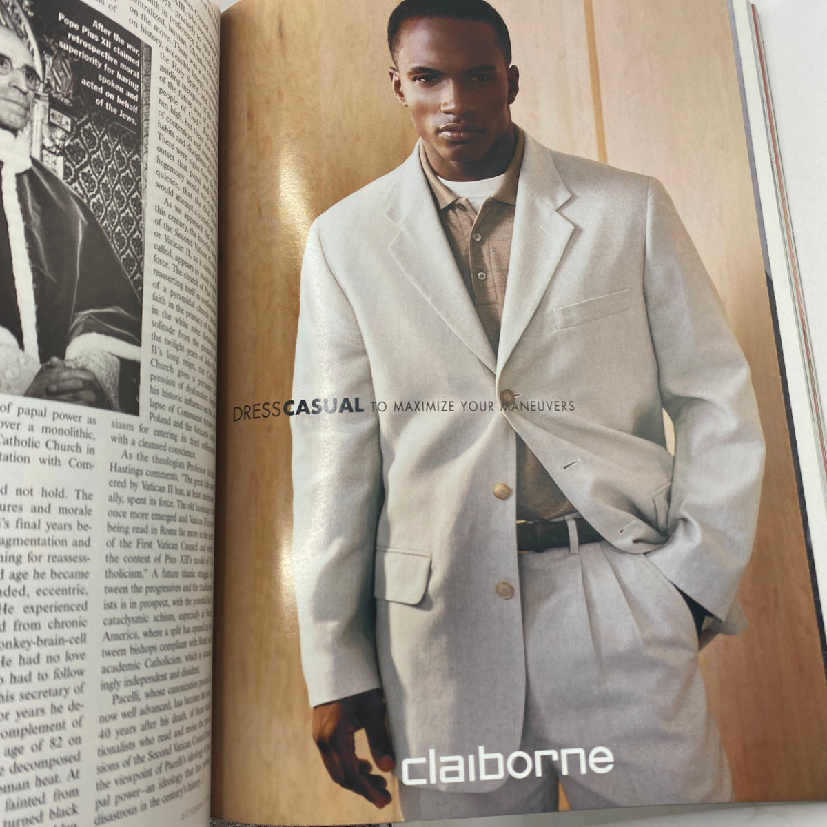 Fashion advertisement from Vanity Fair Magazine October 1999 featuring a model in a light-colored suit, promoting the brand Claiborne under the caption 'DRESS CASUAL TO MAXIMIZE YOUR MANEUVERS'.