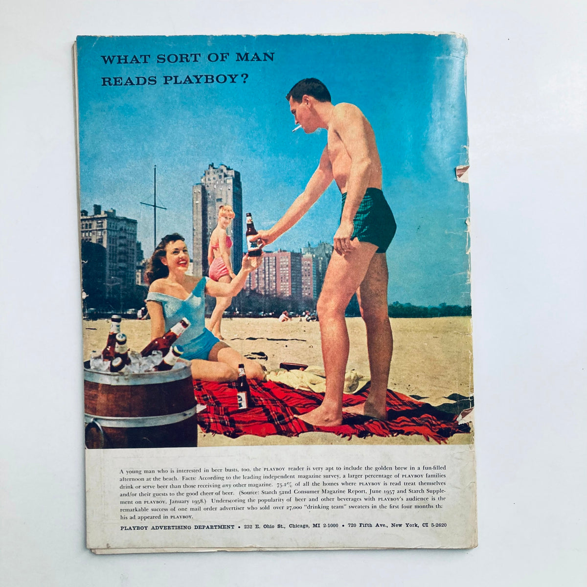 Back cover of VTG Playboy Magazine July 1958 depicting a beach scene with a couple enjoying drinks, illustrating the social culture of the 1950s.