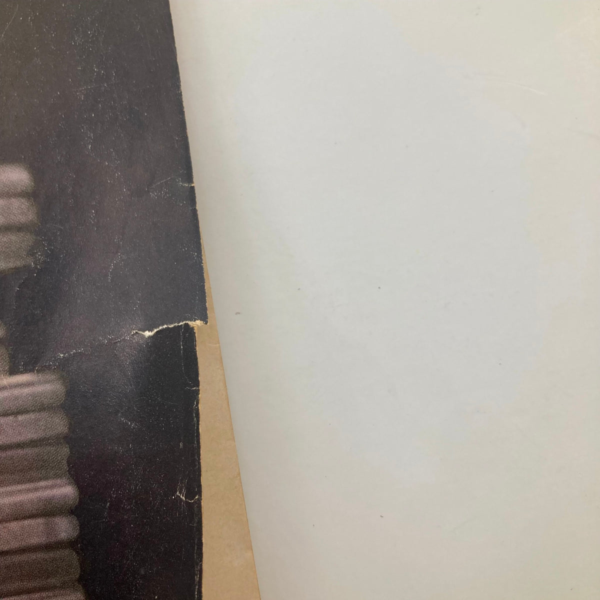 Close-up of the corner of a VTG Playboy Magazine April 1960, displaying wear and aging, illustrating its vintage condition.