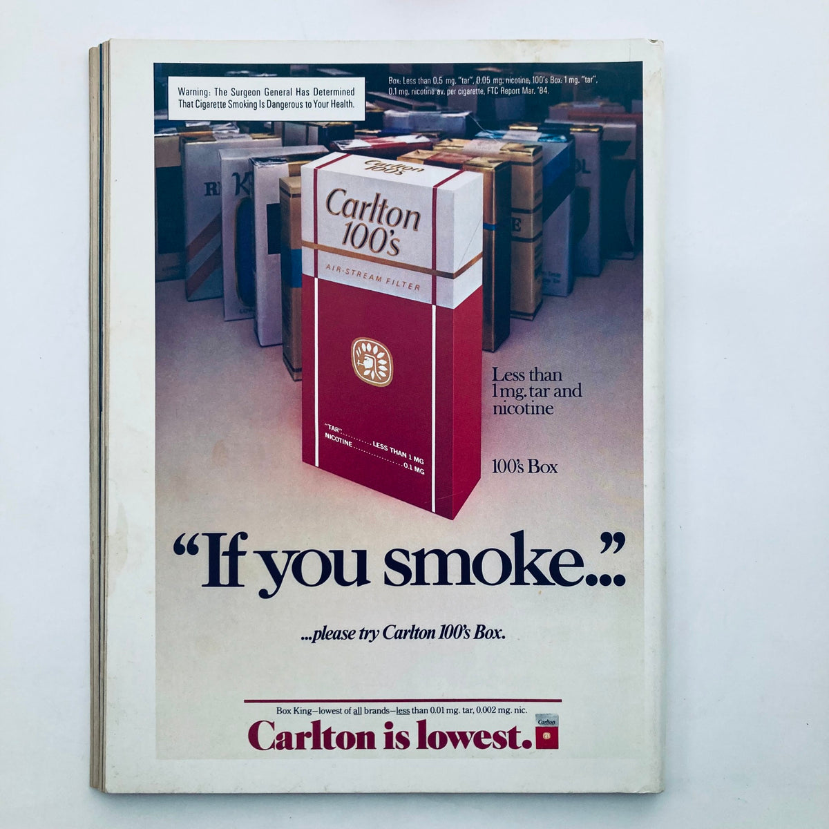 Advertisement from Vintage Playboy Magazine October 1984 promoting Carlton 100's cigarettes, illustrating the packaging and health warning typical of the era. An example of 1980s advertising in magazines.