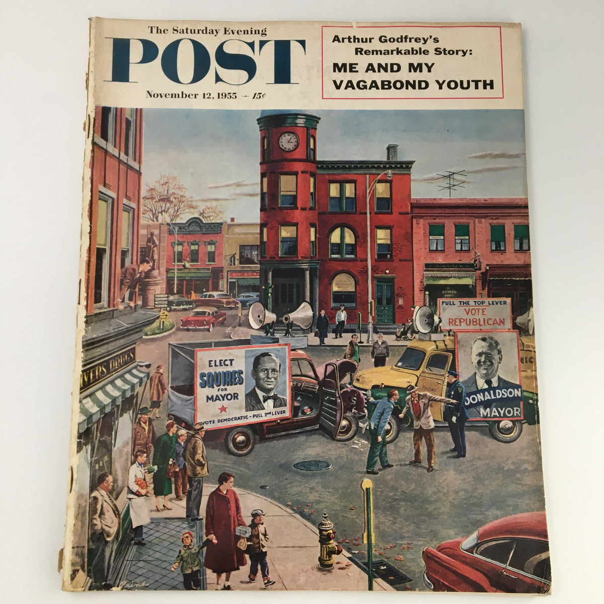 The Saturday Evening Post November 12 1955 cover featuring Arthur Godfrey's story 'Me and My Vagabond Youth', showcasing a colorful mid-20th century street scene with vintage cars and people.