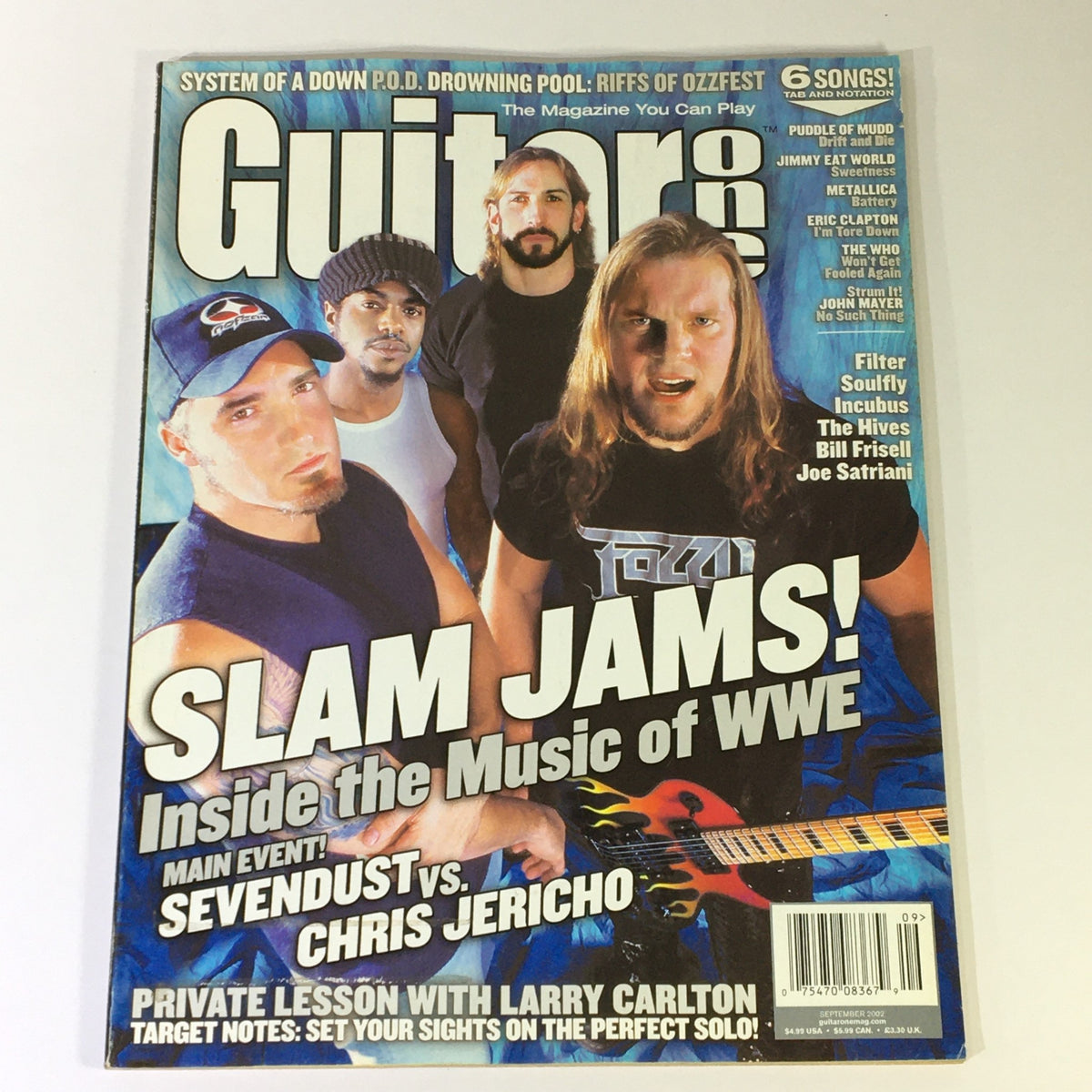 Guitar One Magazine September 2002 featuring a cover story on Filter, Larry Carlton, Chris Jericho, and wrestling music. The magazine highlights 'Slam Jams' and includes articles on various artists from the early 2000s music scene.