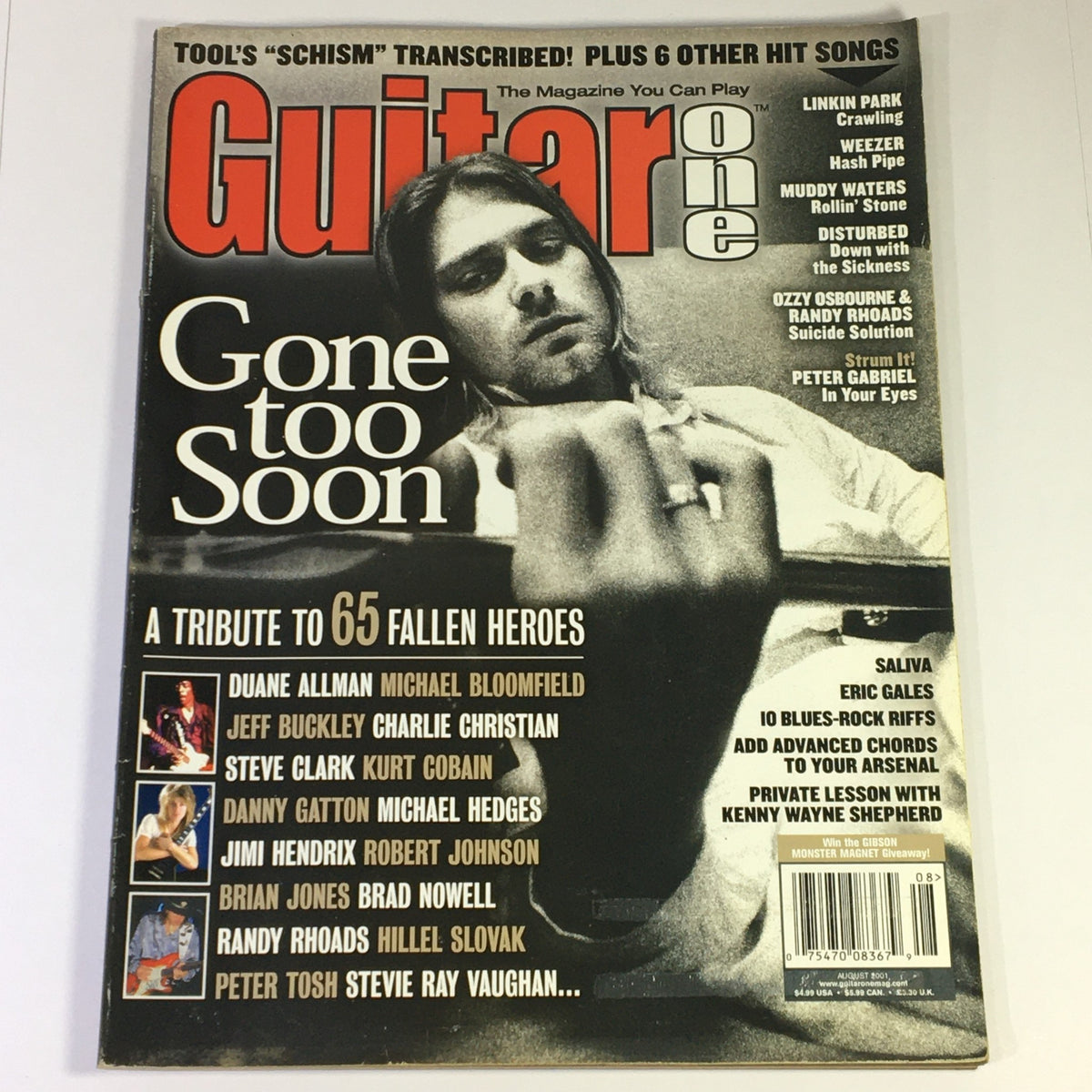 Guitar One Magazine August 2001 cover featuring a tribute to legends Duane Allman, Michael Bloomfield, and Kurt Cobain, highlighting a collection of articles celebrating 65 fallen heroes in music, with features on influential guitarists and rock legends.