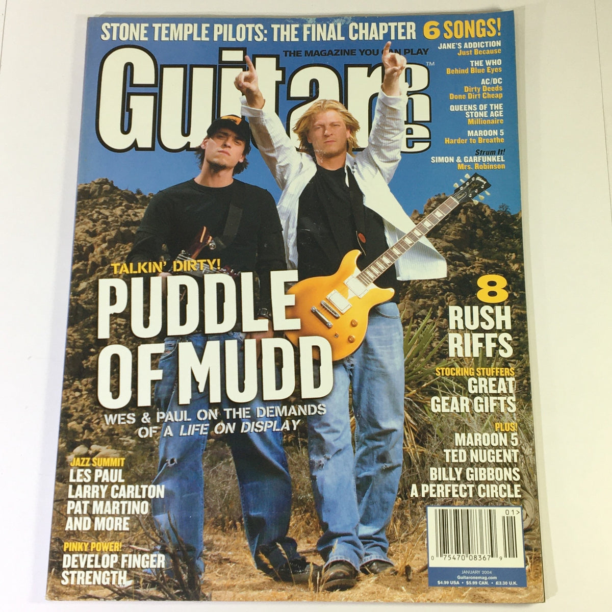 Cover of Guitar One Magazine, January 2004, featuring Puddle of Mudd band members, Les Paul, and Larry Carlton. Highlights articles on music history and rock culture.
