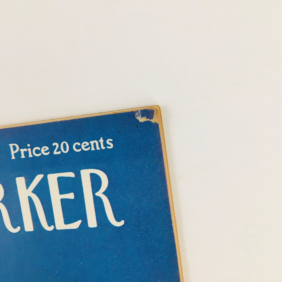 Close-up view of the edge of The New Yorker Magazine January 12, 1952, showing a small rip, indicative of its vintage condition and charm.