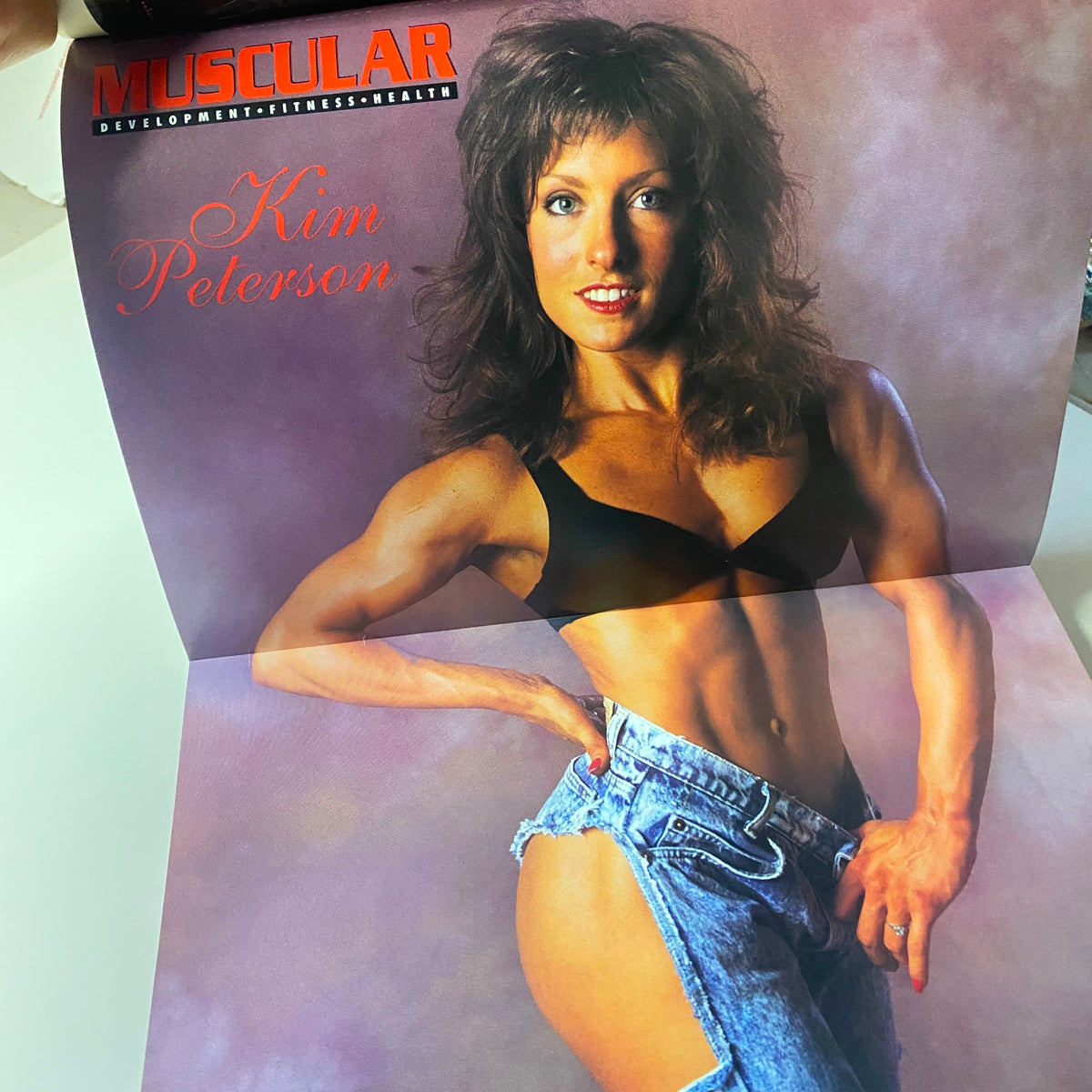 Inside poster of Muscular Development Magazine, October 1994, featuring Kim Peterson, showcasing her impressive physique and modeling in bodybuilding fashion.