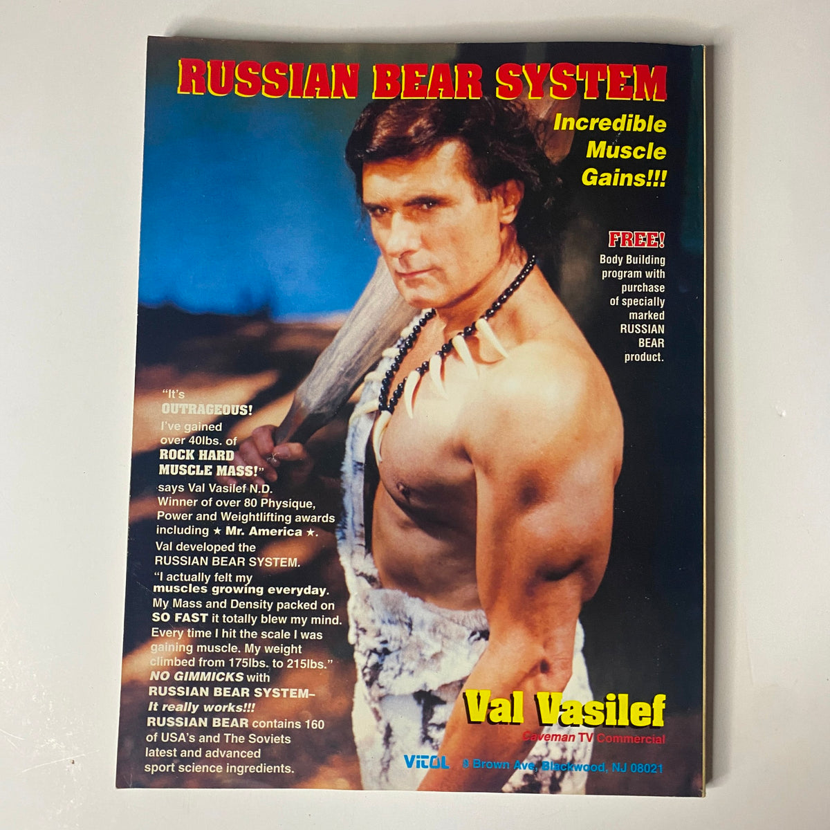 Promotional image for Russian Bear System, showcasing Val Vasilef, depicted as a muscular figure in an animal-skin outfit, promoting muscle-building techniques in a retro fitness advertisement.