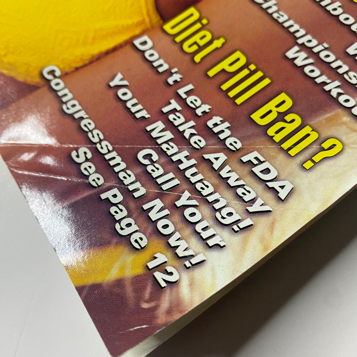 Close-up of the text on the cover of Muscular Development Magazine December 1996, discussing a diet pill ban and its implications.