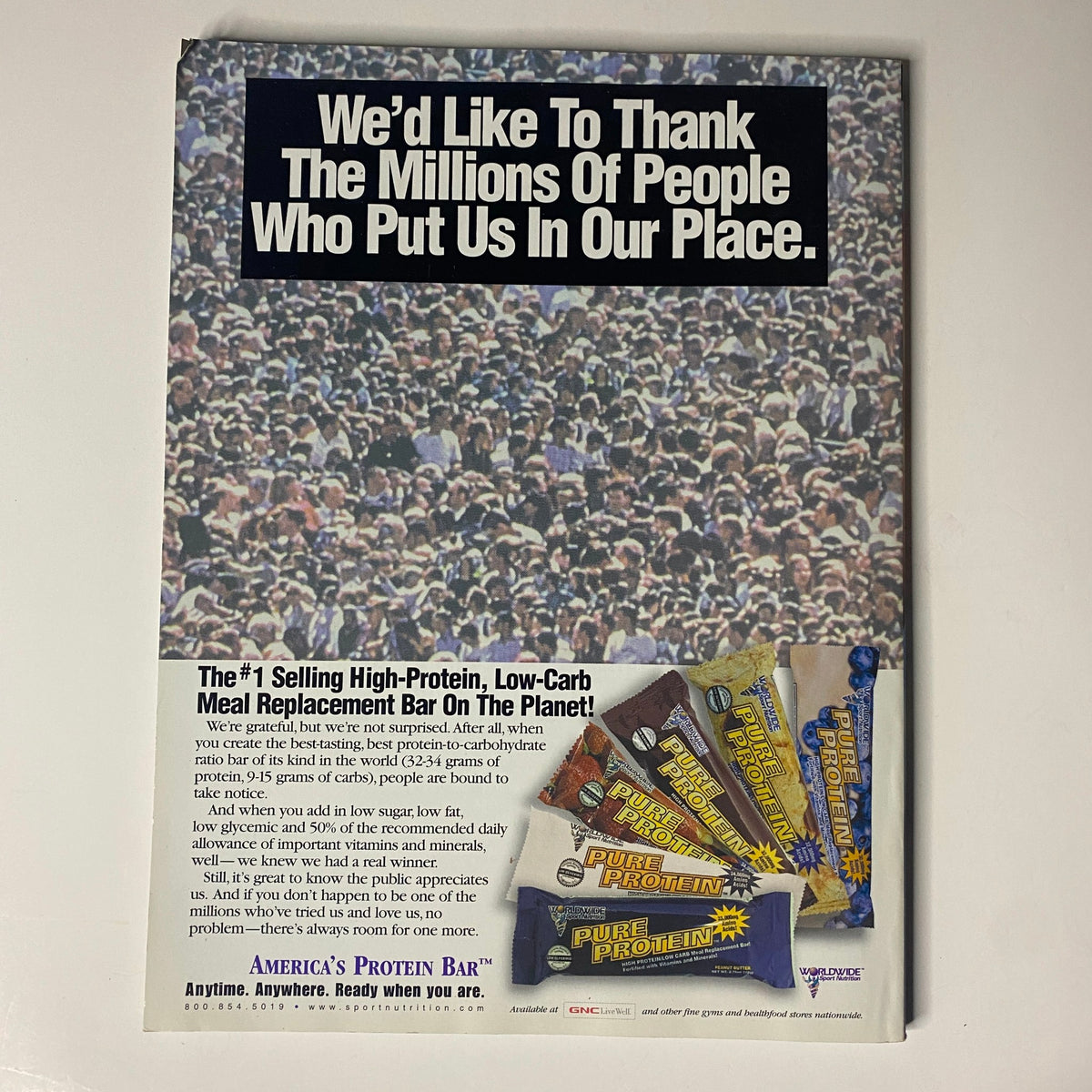 Advertisement from Muscular Development Magazine June 2000 featuring a crowd, thanking supporters, and promoting Pure Protein Bars as the #1 selling high-protein, low-carb meal replacement bar, highlighting fitness and nutrition.
