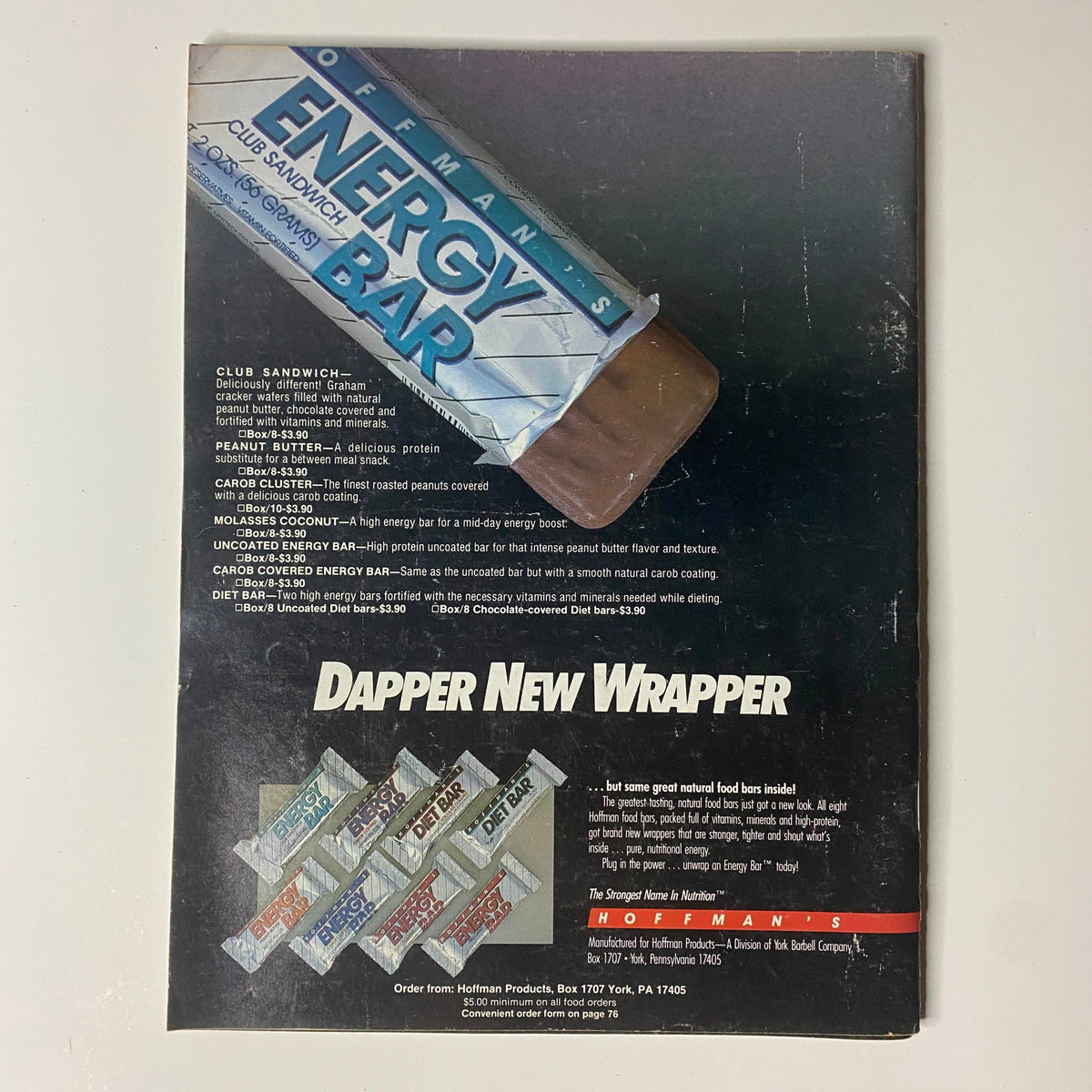 Back cover of Muscular Development Magazine April 1987 showcasing an advertisement for 'Energy Bar' by Hofmann, emphasizing the product benefits and new packaging design.