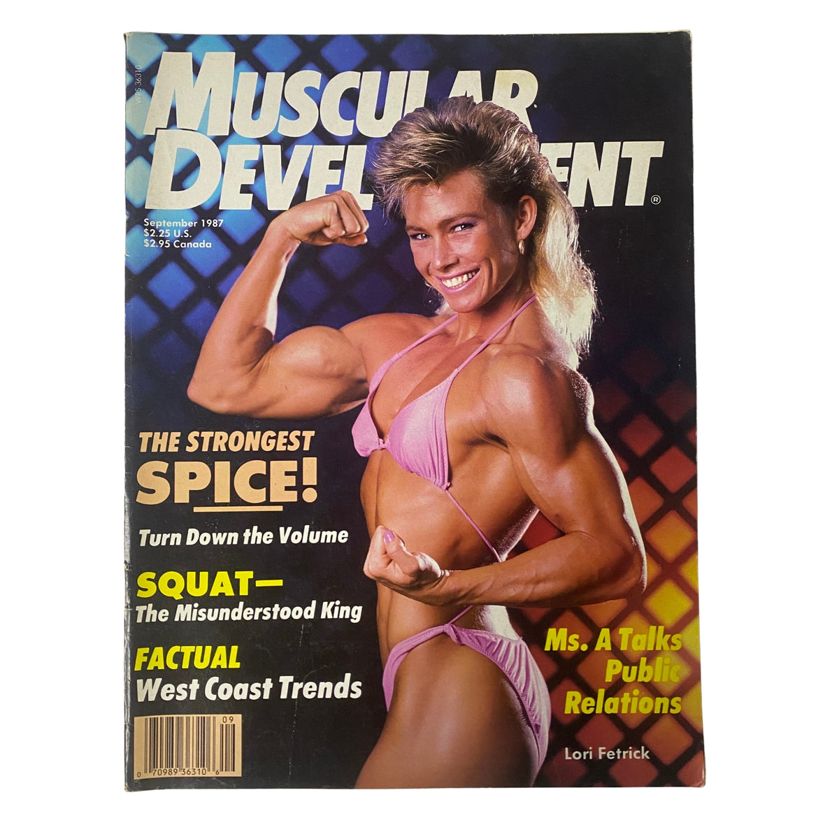 Cover of Muscular Development Magazine September 1987 featuring Lori Fetrick showcasing her impressive physique in a pink bikini while flexing her muscles.