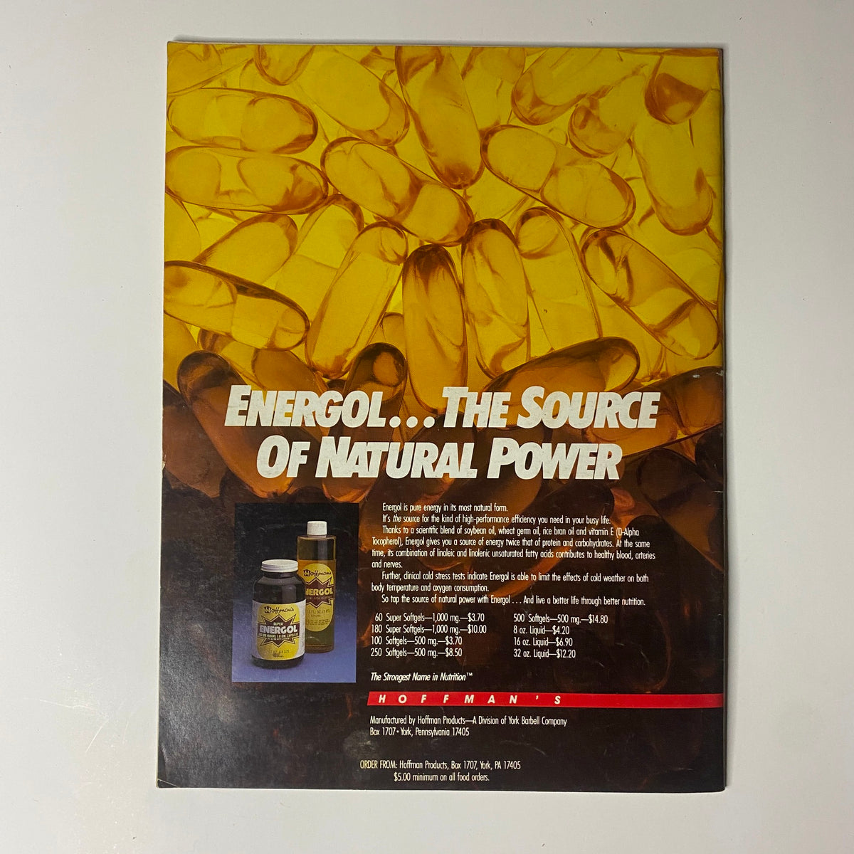 Back cover of Muscular Development Magazine March 1988 advertising Energol, a natural supplement. The design features capsules and promotes fitness enhancement products. Ideal for bodybuilding enthusiasts.